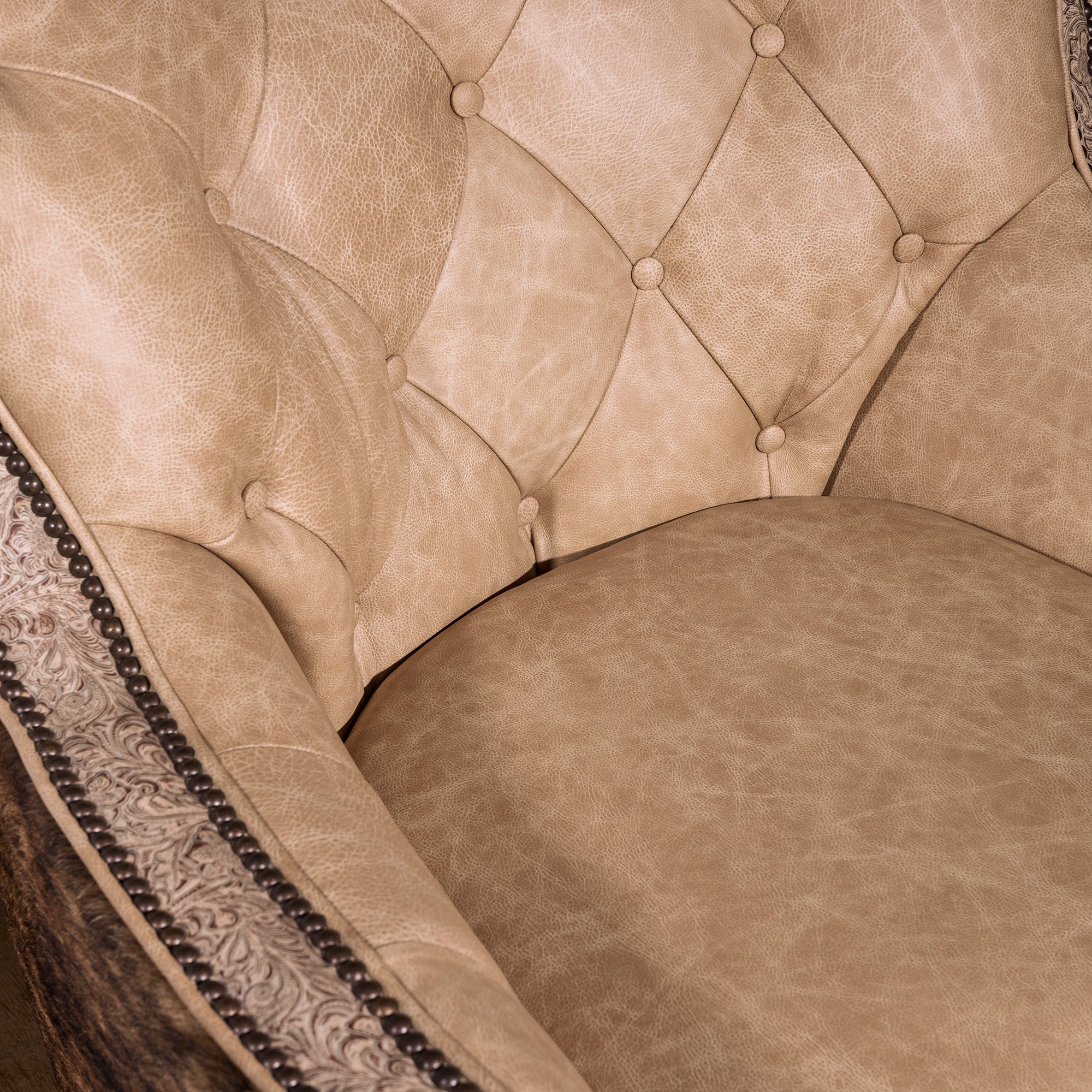 Detail of plush pearl leather seat cushion on luxury Western swivel chair