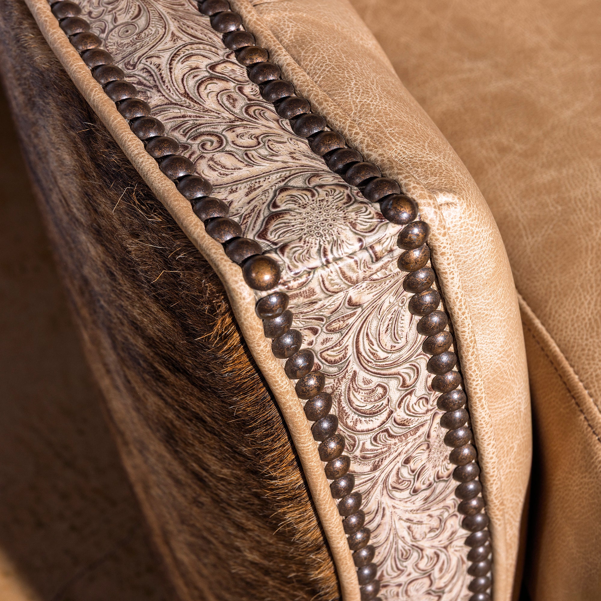 Tooled leather arm trim with nailhead detail on Prairie Pearl swivel chair