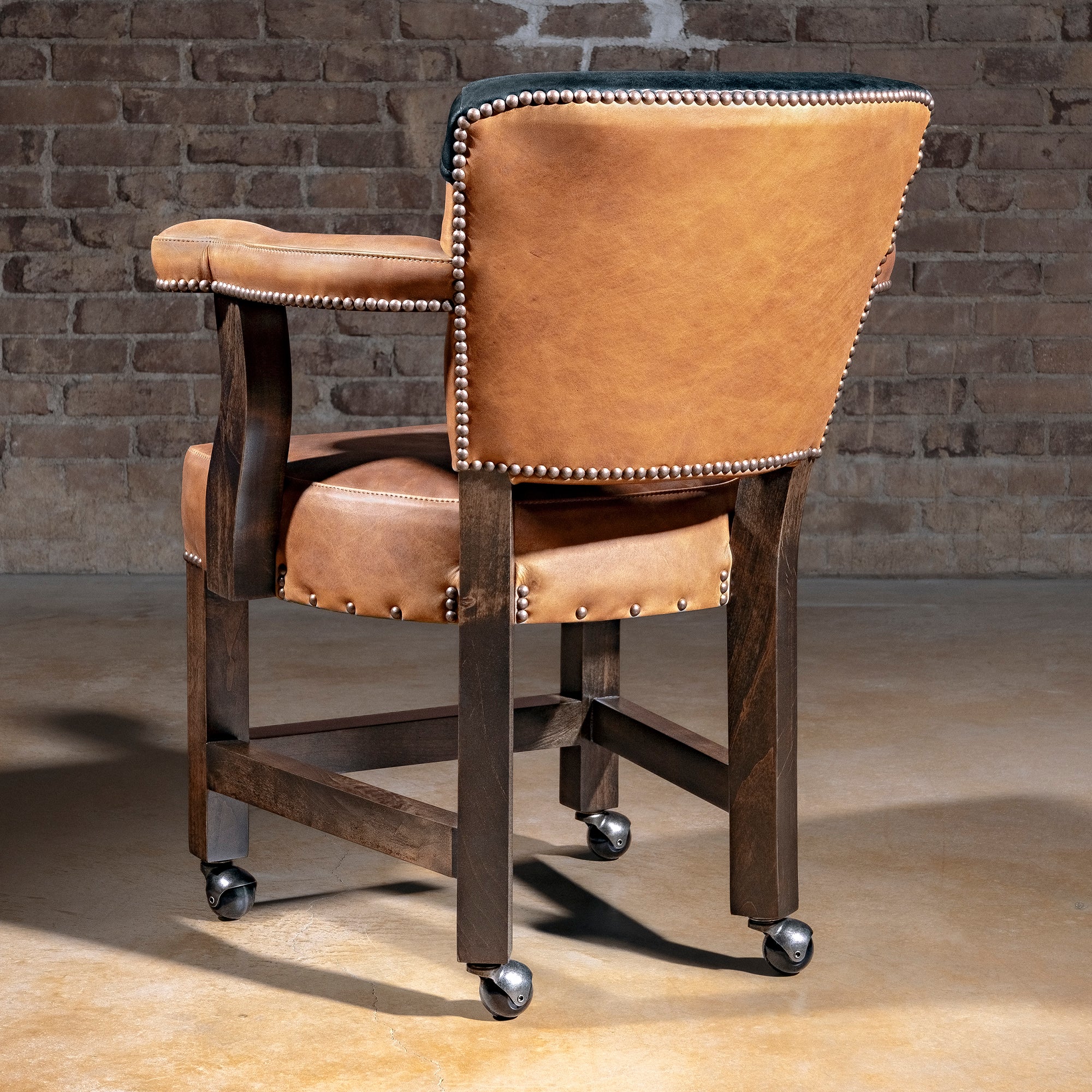 Presidio Dealer Chair western poker chair in tan top-grain leather with black yoke back, alder wood base, and casters
