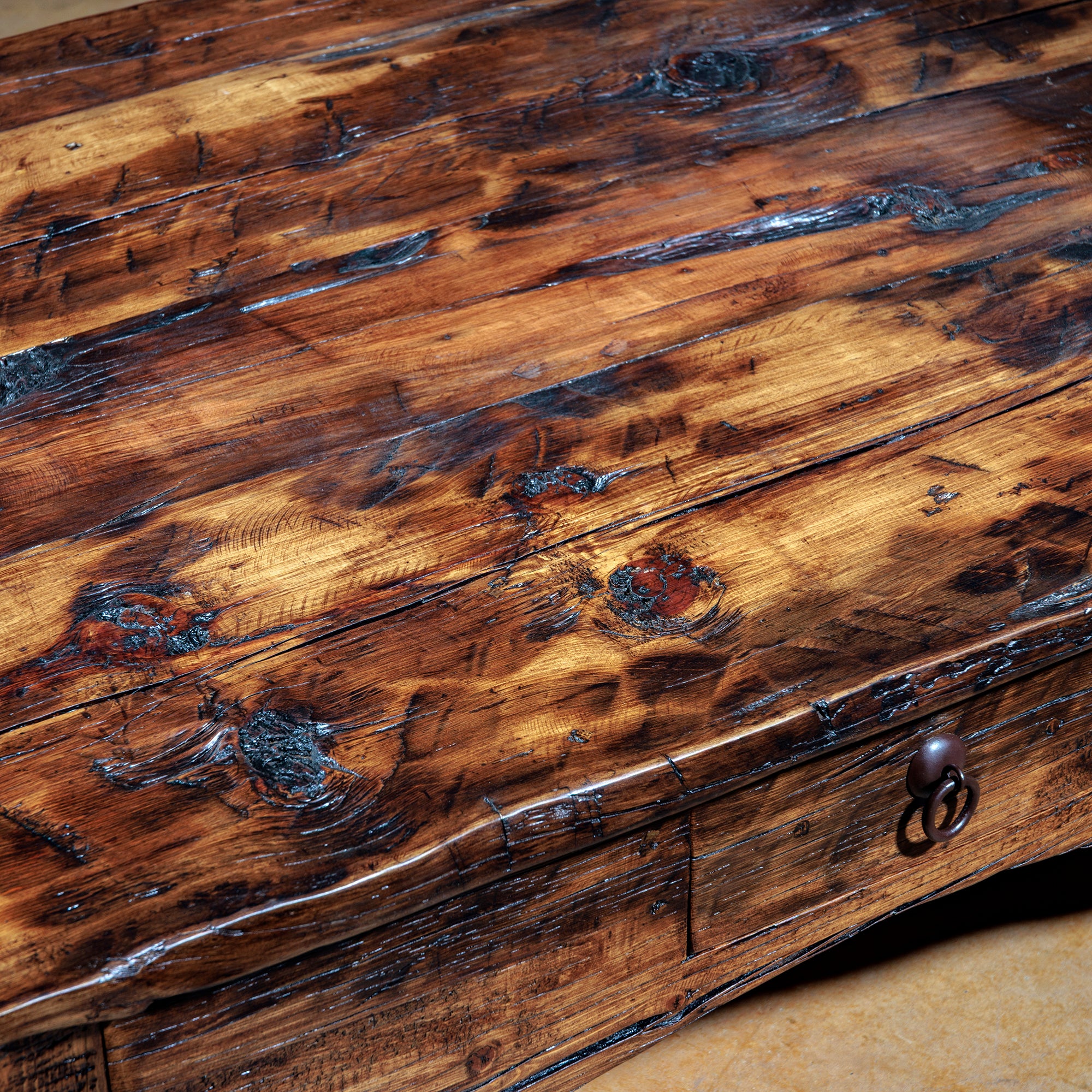 Reclaimed wood tabletop with knots, saw marks, and burnished edges