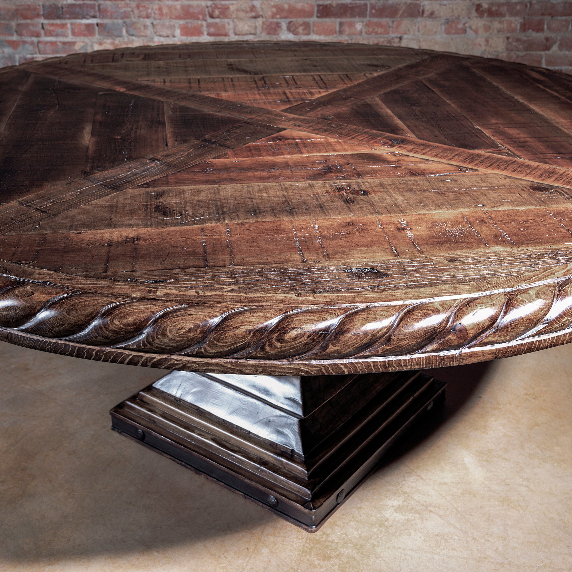 Inlaid reclaimed wood plank pattern on round Western dining table