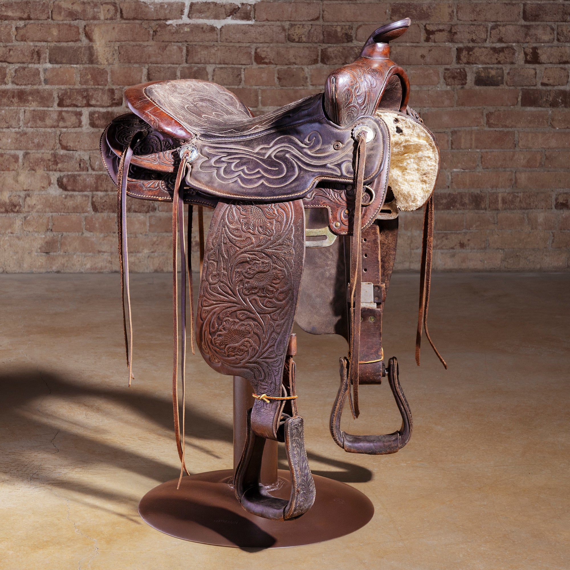 Authentic retired cowboy saddle converted into a one-of-one Western bar stool with iron base — Retired Saddle No. 031