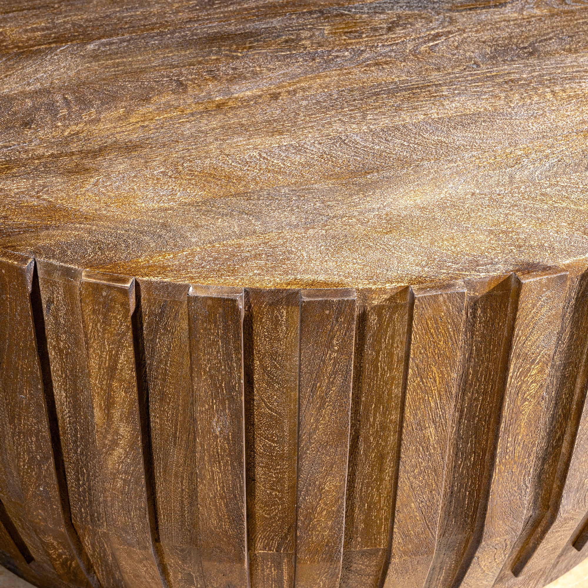 Ridgeline Drum Coffee Table high angle detail showing carved wood ridges, round top, and Western great room character