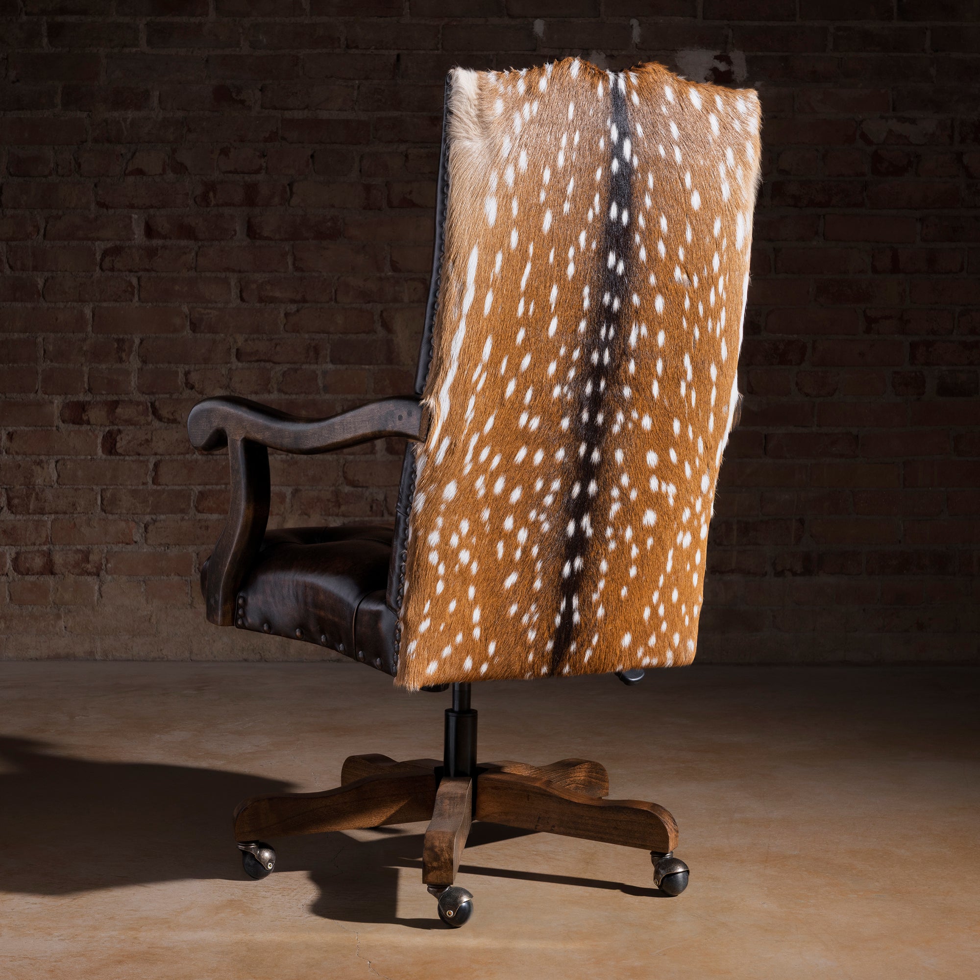 Back view of Western desk chair showing axis hide panel and nailhead trim