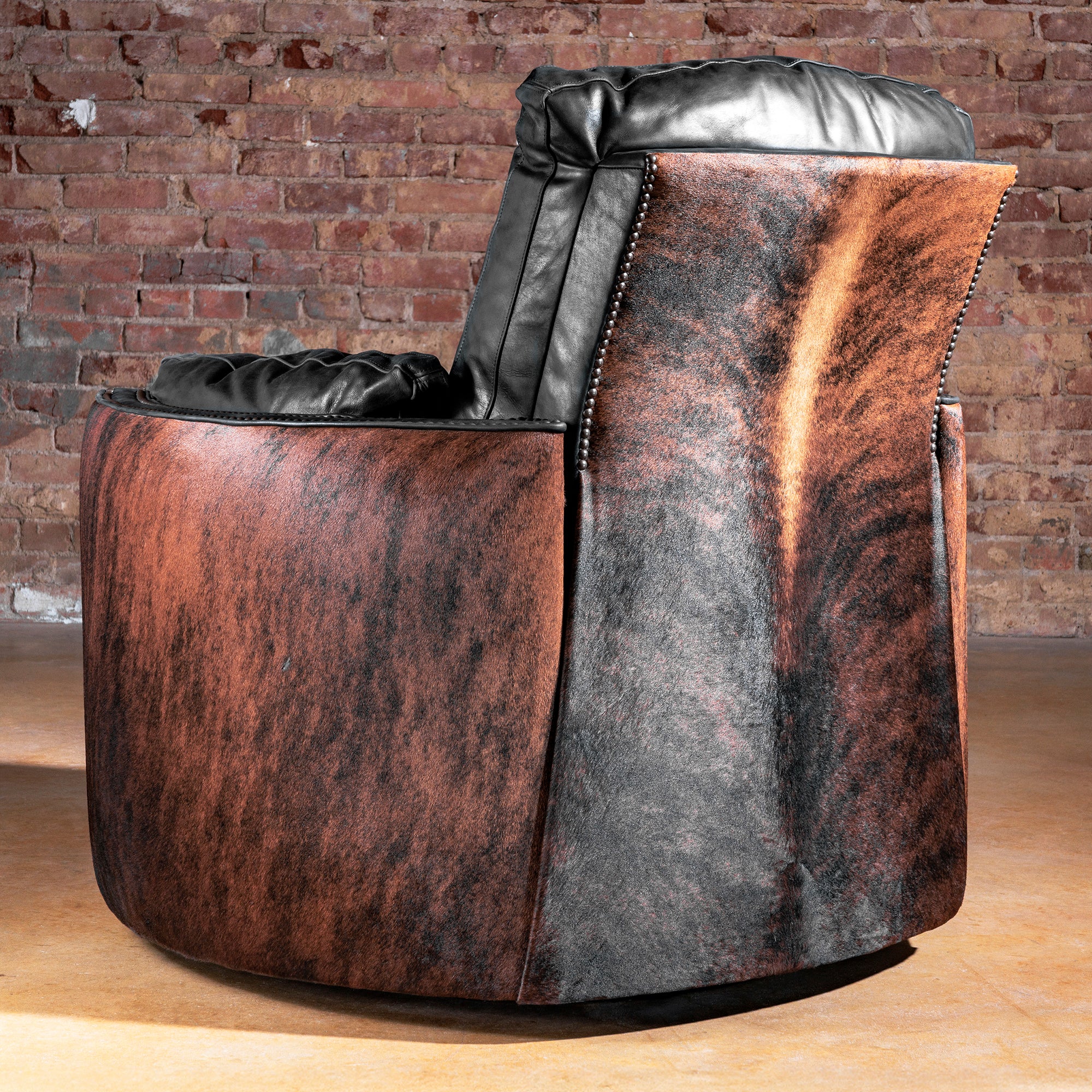 Rear view showing Brazilian brindle cowhide wrap and nailhead trim—Rio Lobo Brindle Cuddler Recliner