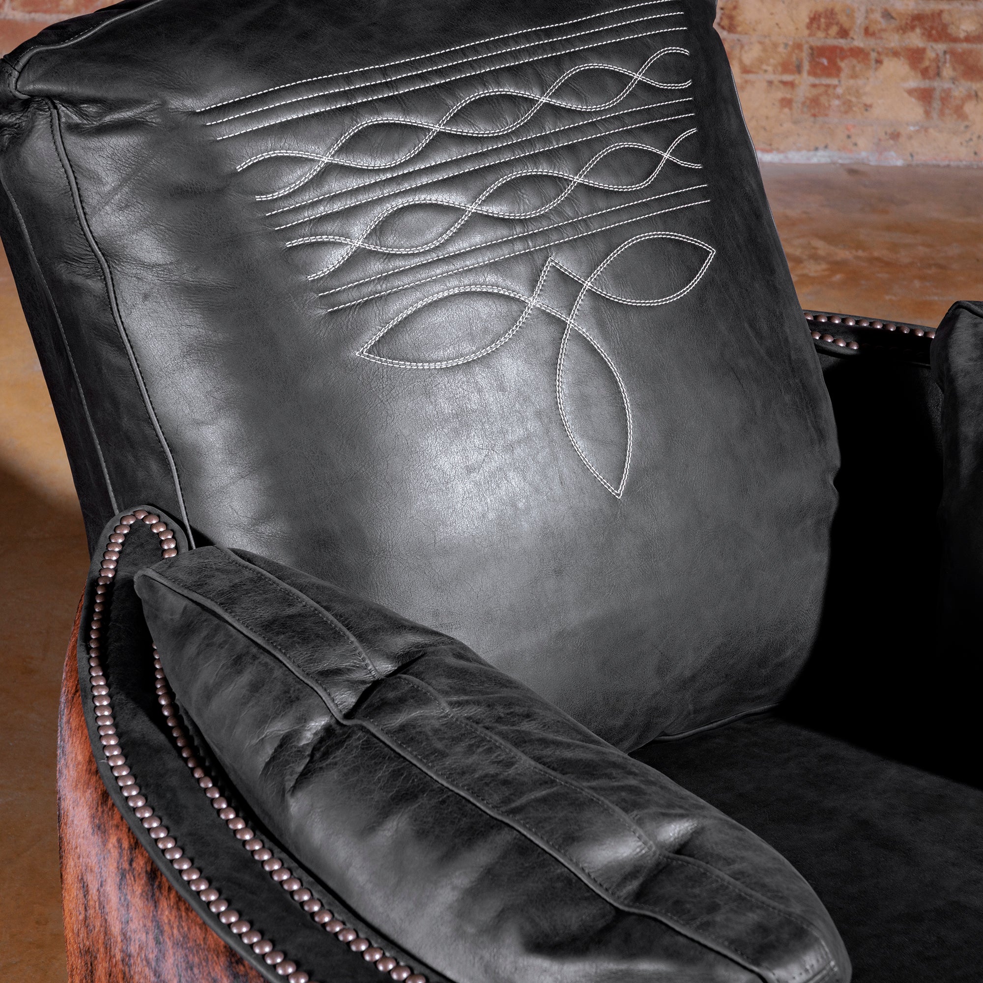 Boot-stitch embroidery detail on black leather back cushion—Rio Lobo Western recliner