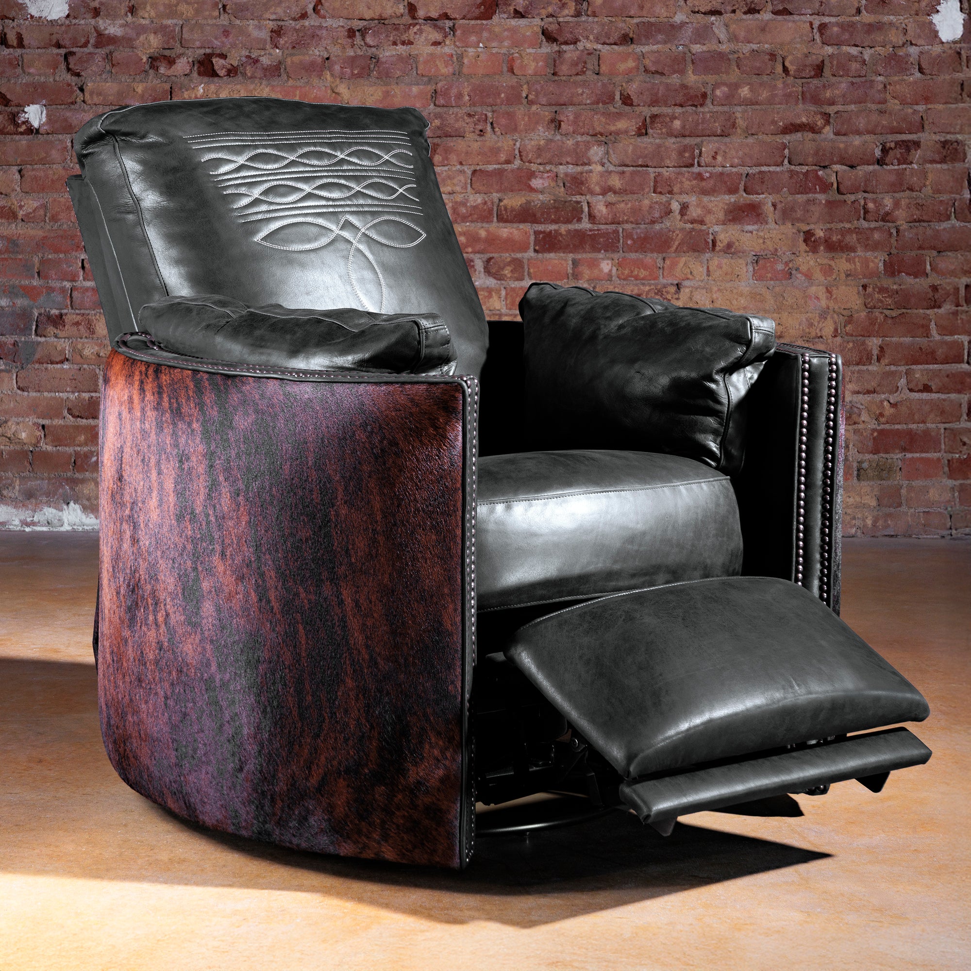 Rio Lobo cuddler recliner fully reclined with 360-swivel base—black leather and brindle cowhide