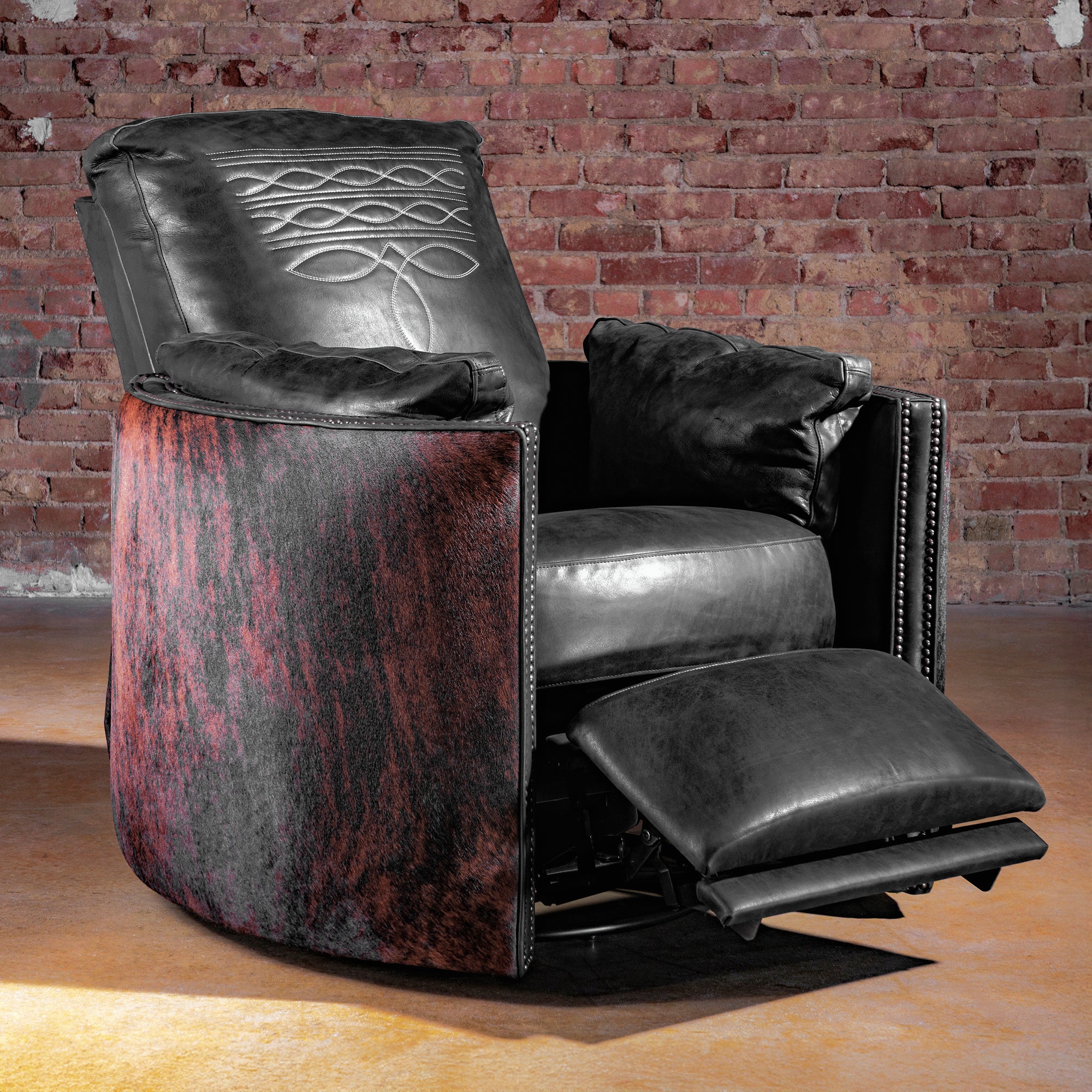 Luxury Western cuddler recliner in black leather with Brazilian brindle cowhide sides and boot-stitch back—Rio Lobo