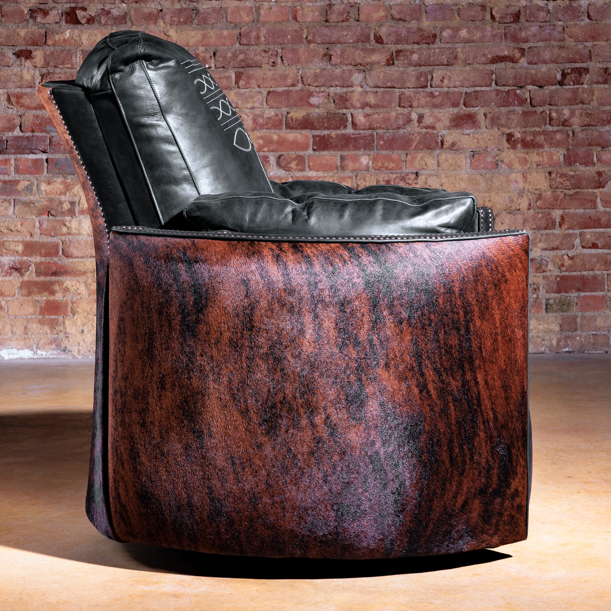 Side profile of Western cuddler recliner showing curved brindle cowhide panel—Rio Lobo