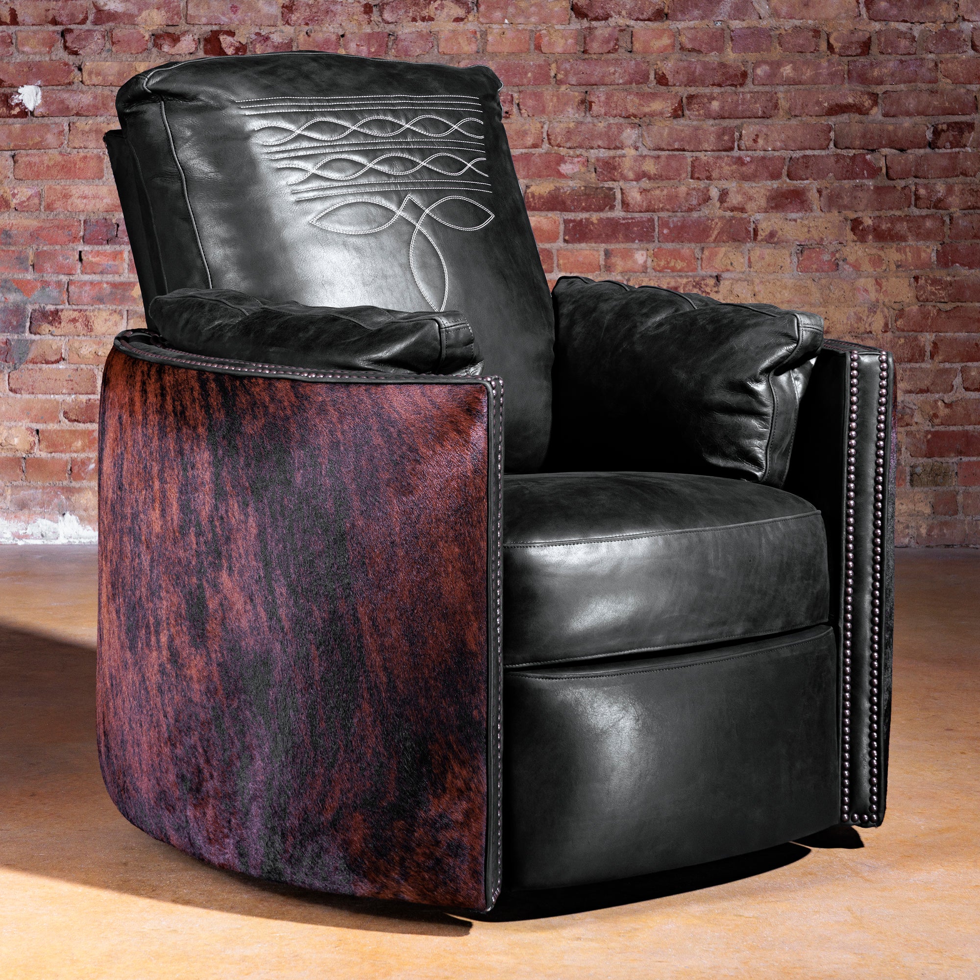 Luxury Western cuddler recliner in black leather with Brazilian brindle cowhide sides and boot-stitch back—Rio Lobo