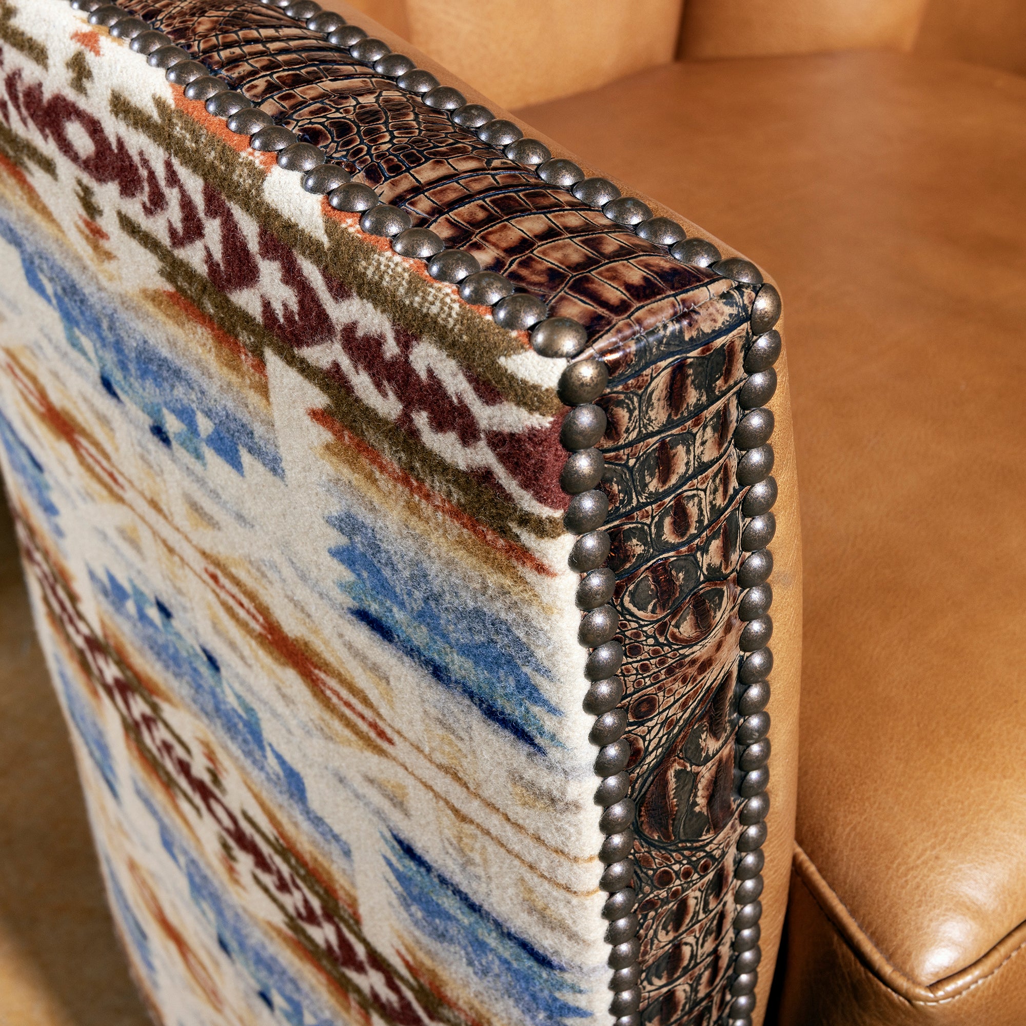 Detail of leather arm, Pendleton fabric, and nailhead trim on Rio Sol Western swivel chair