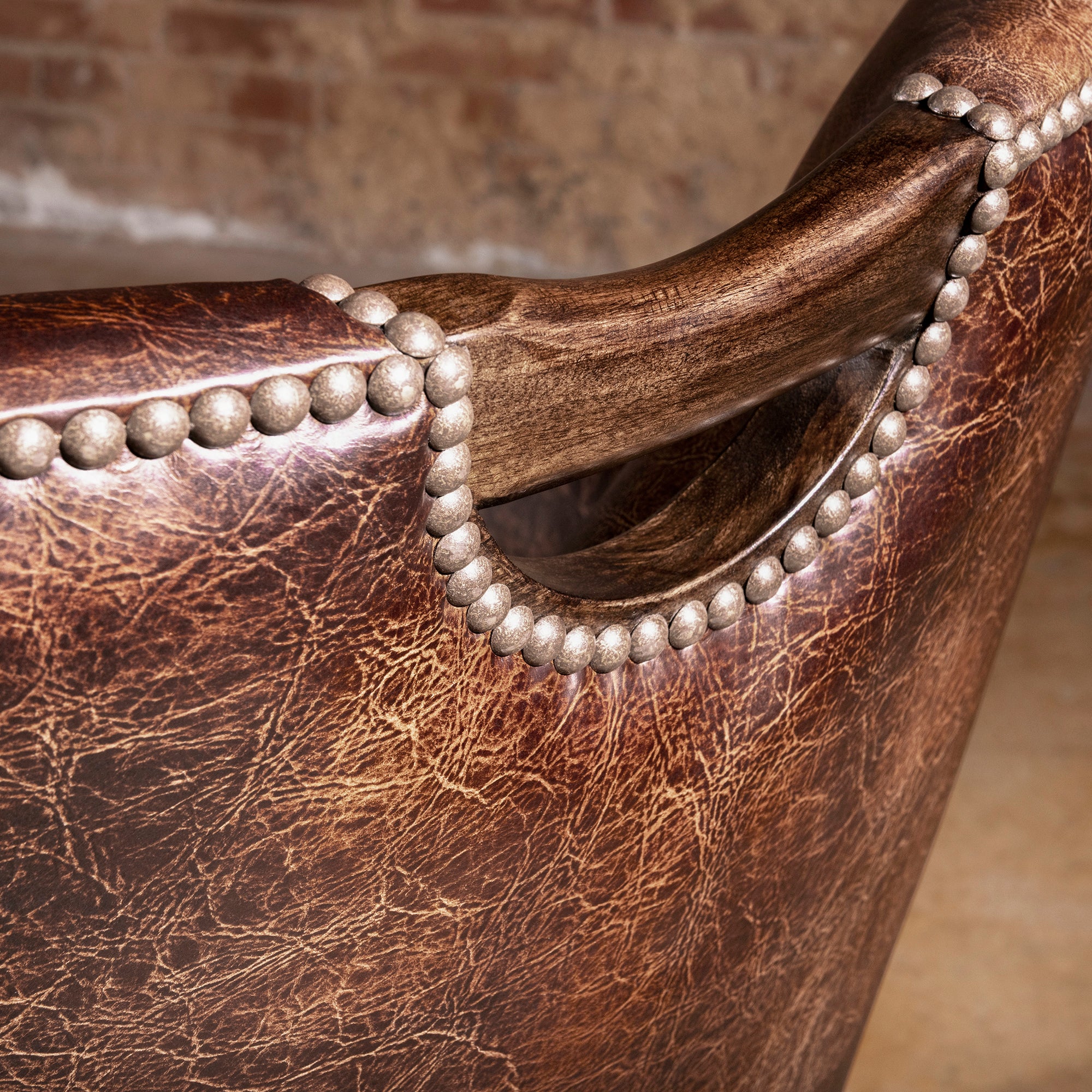 Detail of distressed top-grain leather back panel on rolling game chair