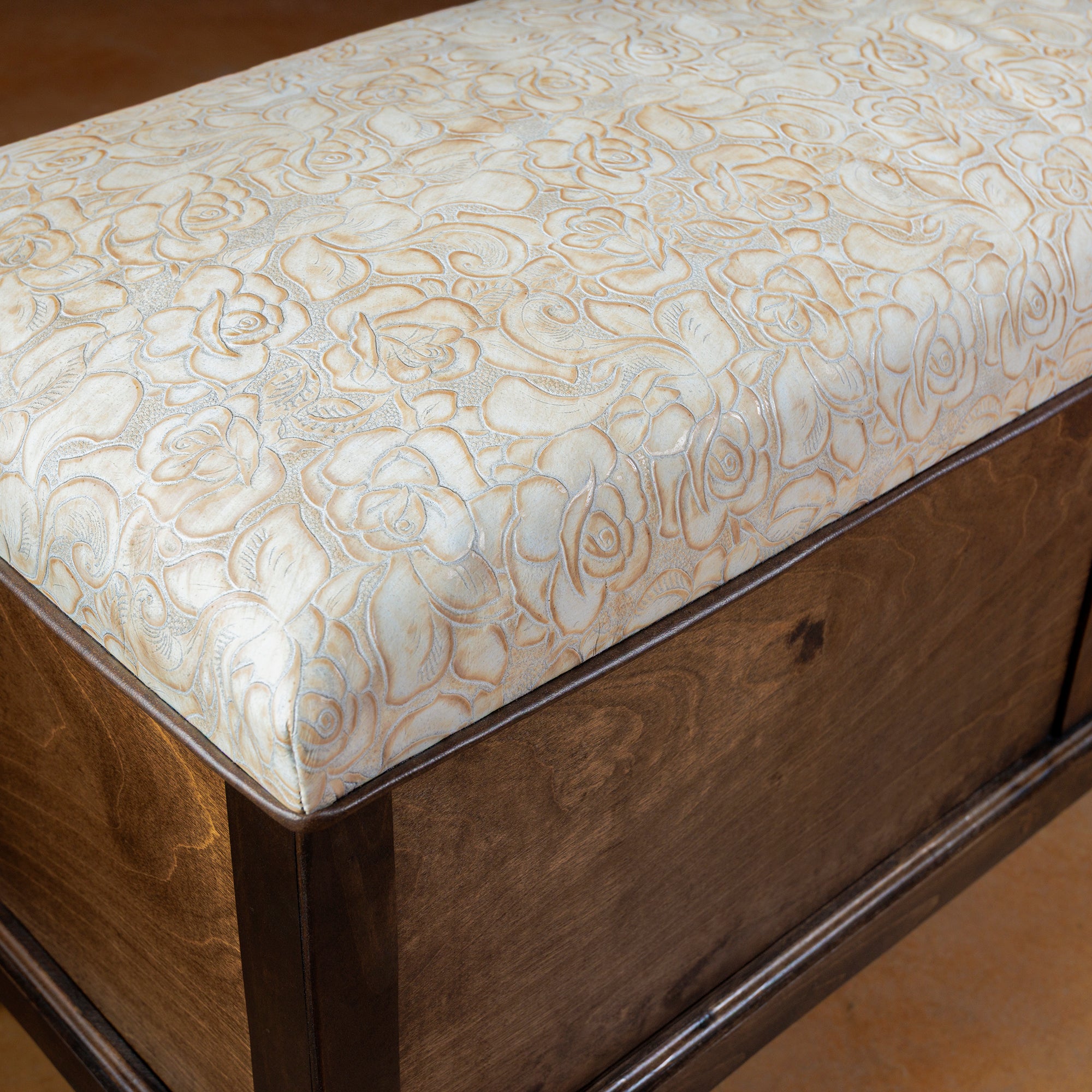 Close-up of ivory stamped leather with floral rose pattern