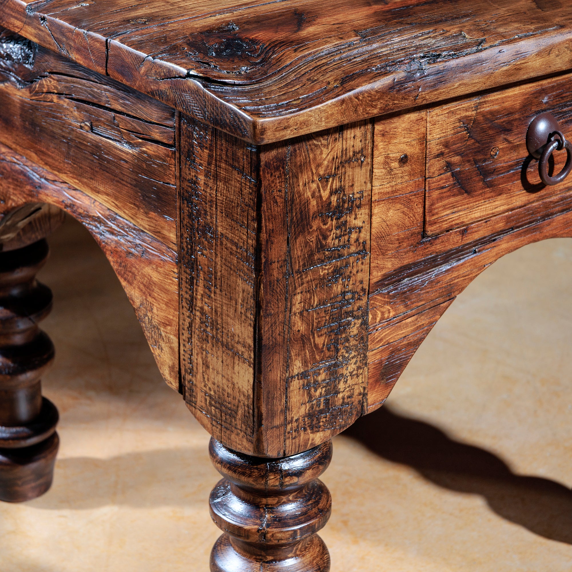 Close-up of carved table leg and wood grain of rustic accent table
