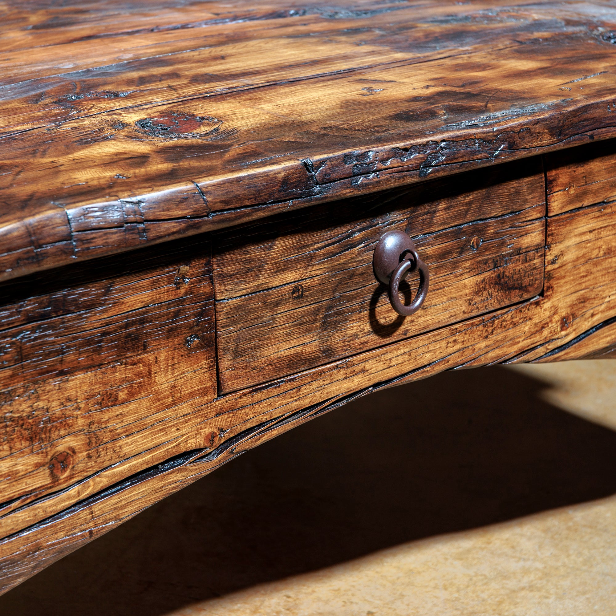 Rustic coffee table with iron ring pull drawer and weathered finish