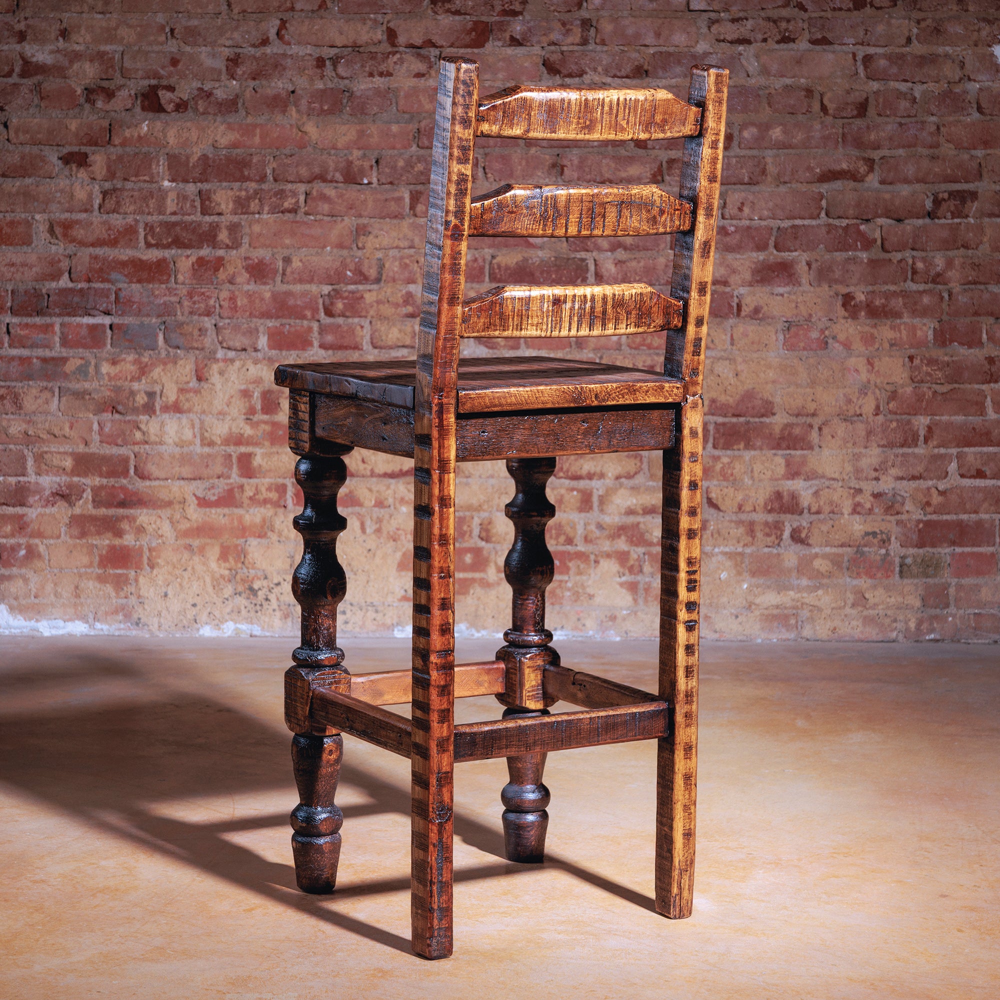 Handcrafted Western bar stool with ladder-back and aged finish
