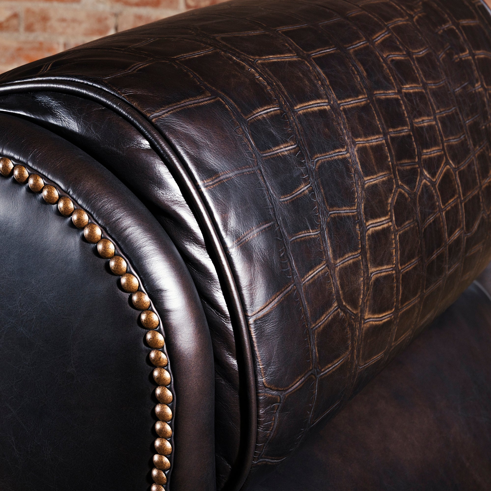 Croc-embossed leather headrest detail on Western executive desk chair with vintage nailhead edge.