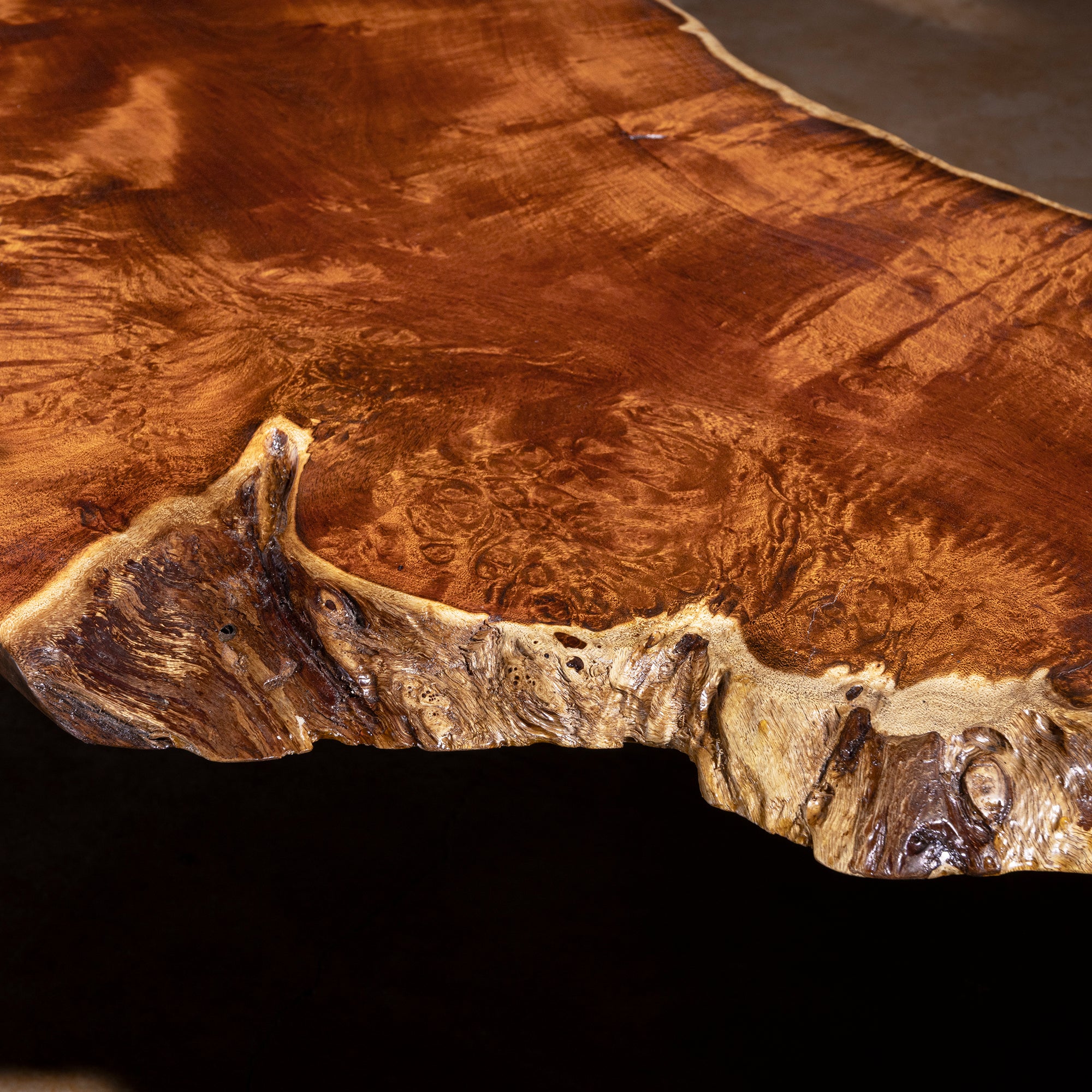 Closeup of natural live-edge detail on Sable Ridge walnut slab coffee table