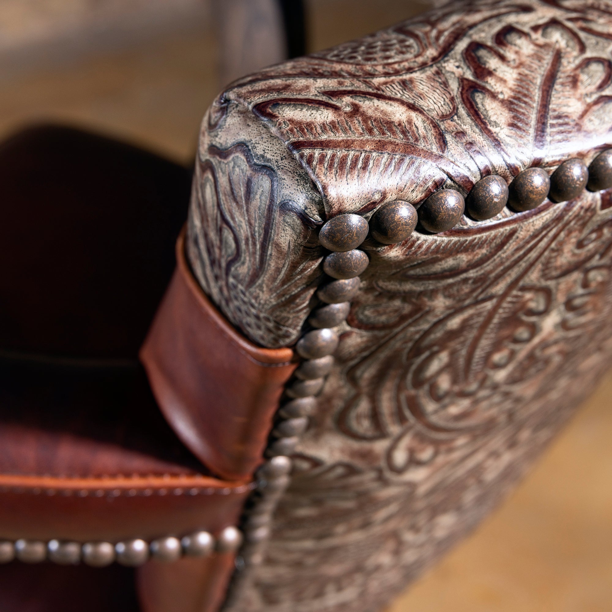 Antique nailhead trim detail on Western leather saddle-style bar stool