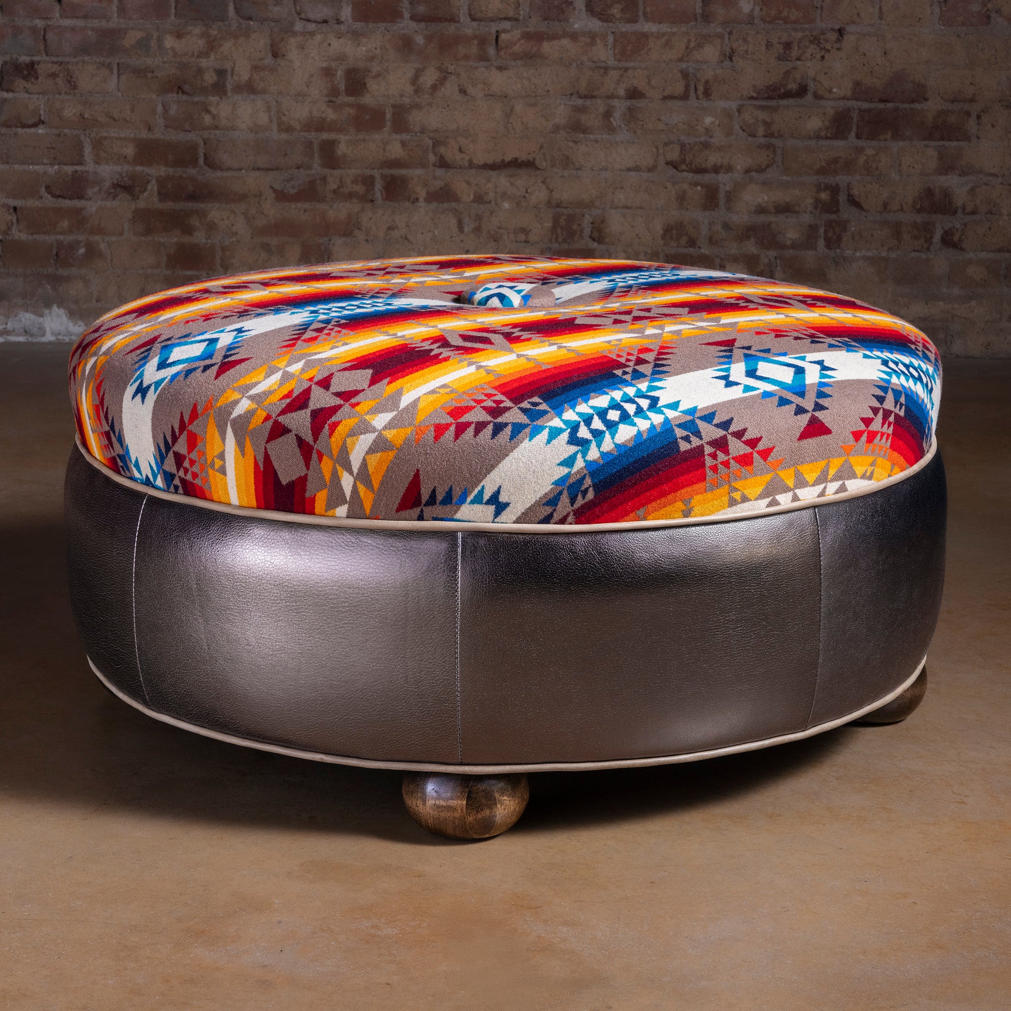 Round Western Pendleton ottoman with Southwest pattern top and golden leather base