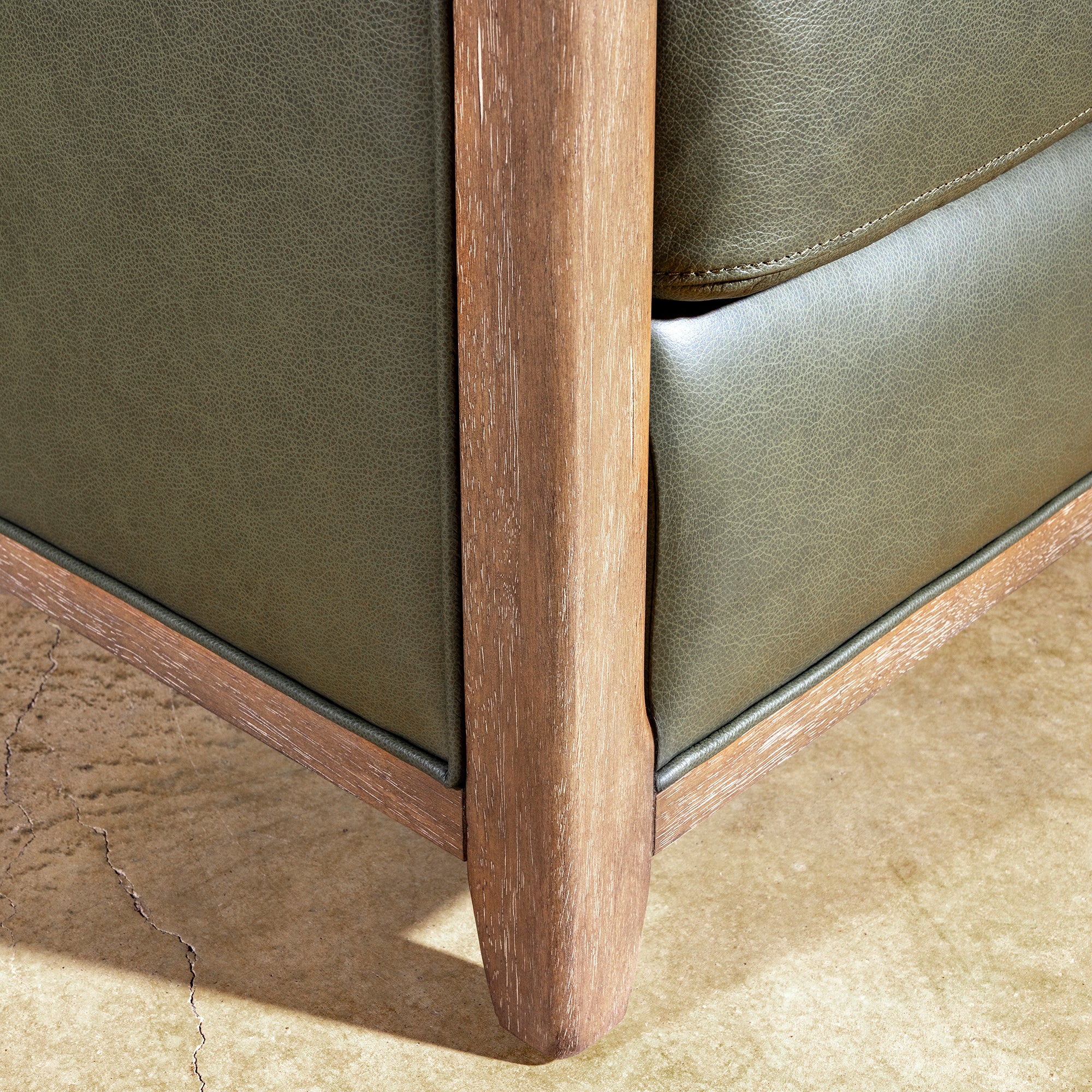 Sagewood Club Chair lower wood frame detail with olive leather side panels and modern Western accent chair styling