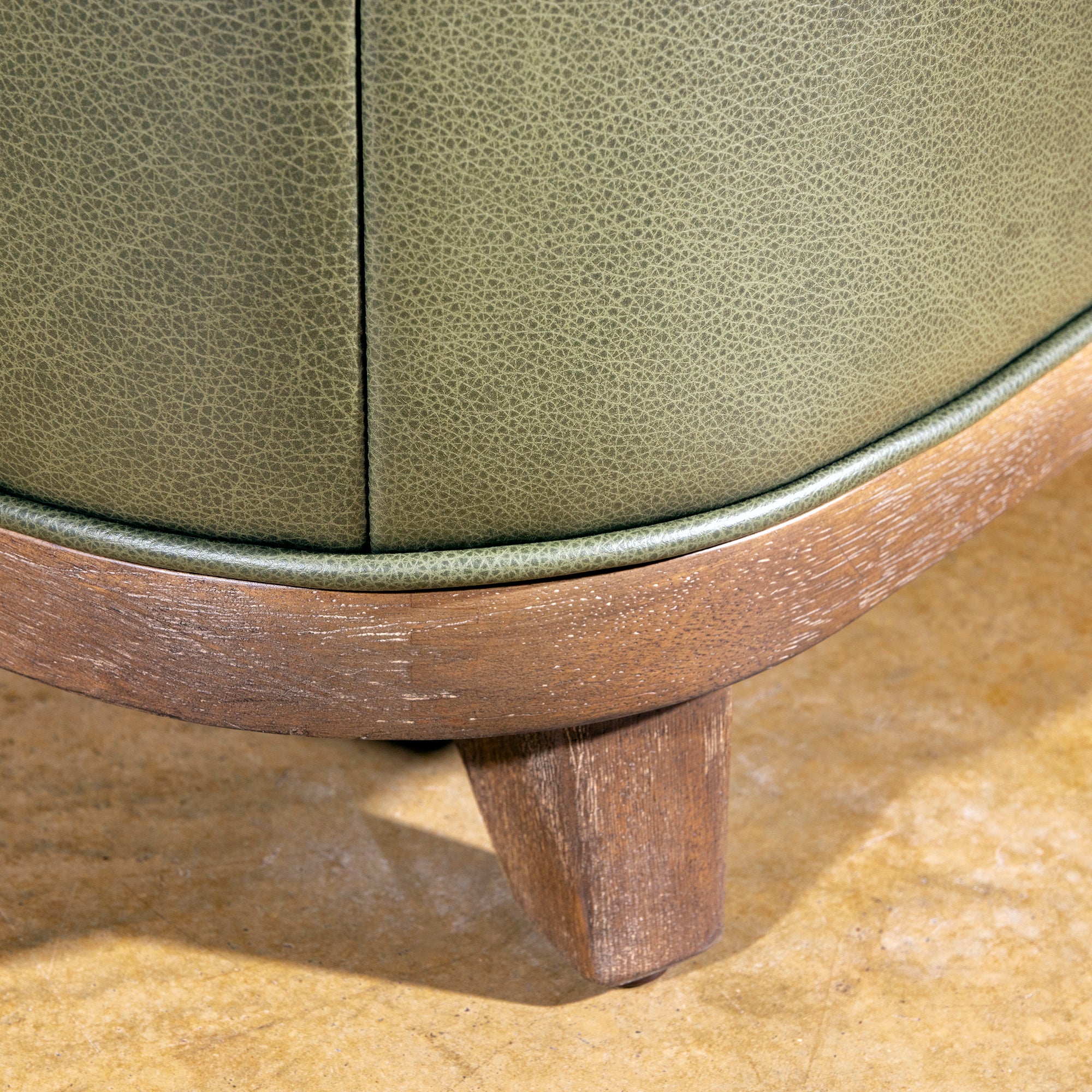 Sagewood Club Chair wood foot detail on a modern Western accent chair with olive leather upholstery and warm frame