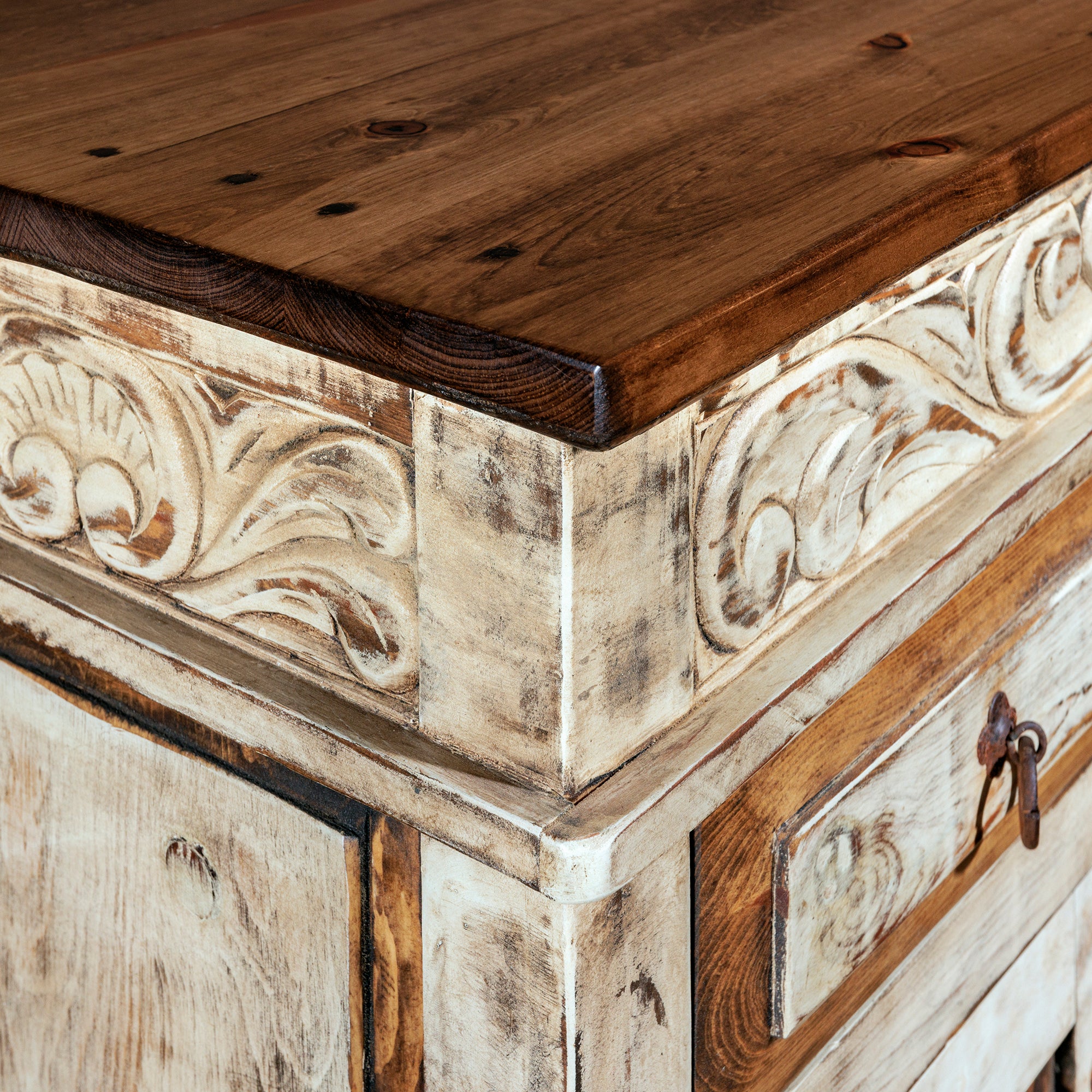 Corner carving and texture detail on handcrafted Santa Ynez console