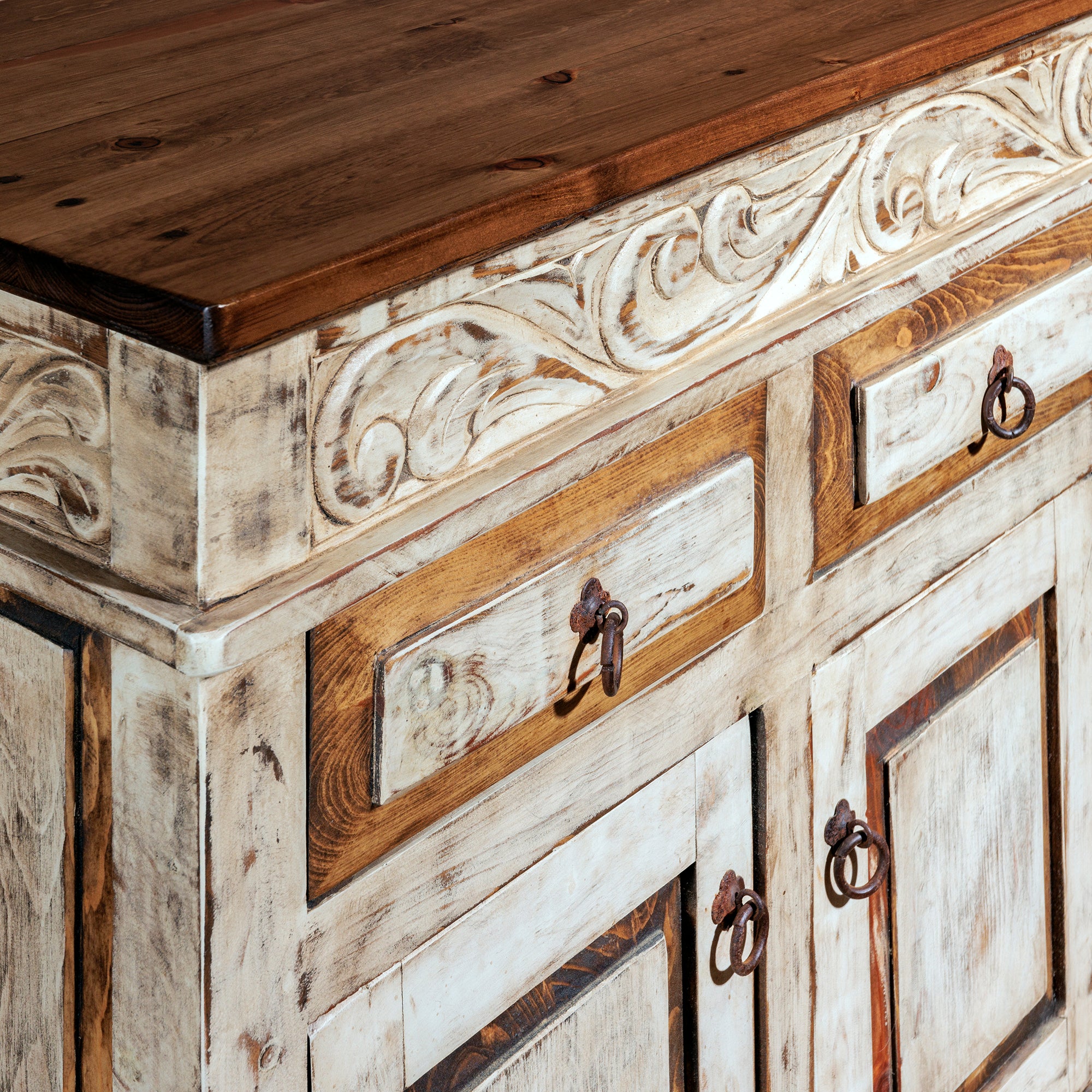 Close-up of carved console leg with distressed wood finish