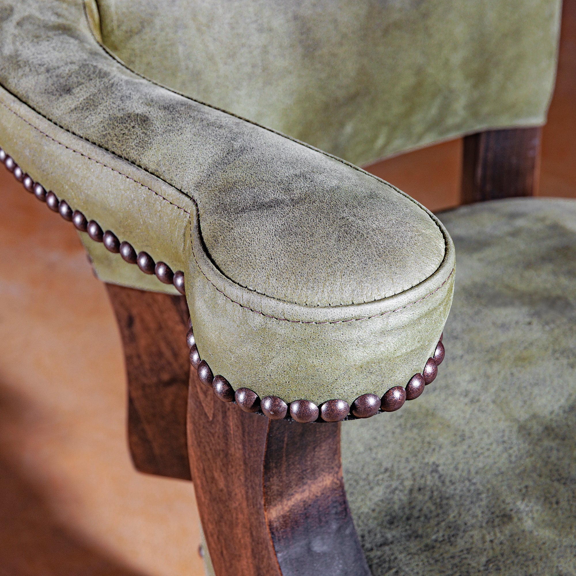 Green leather arm with artisan nailhead trim on Sonora Verde Western bar stool