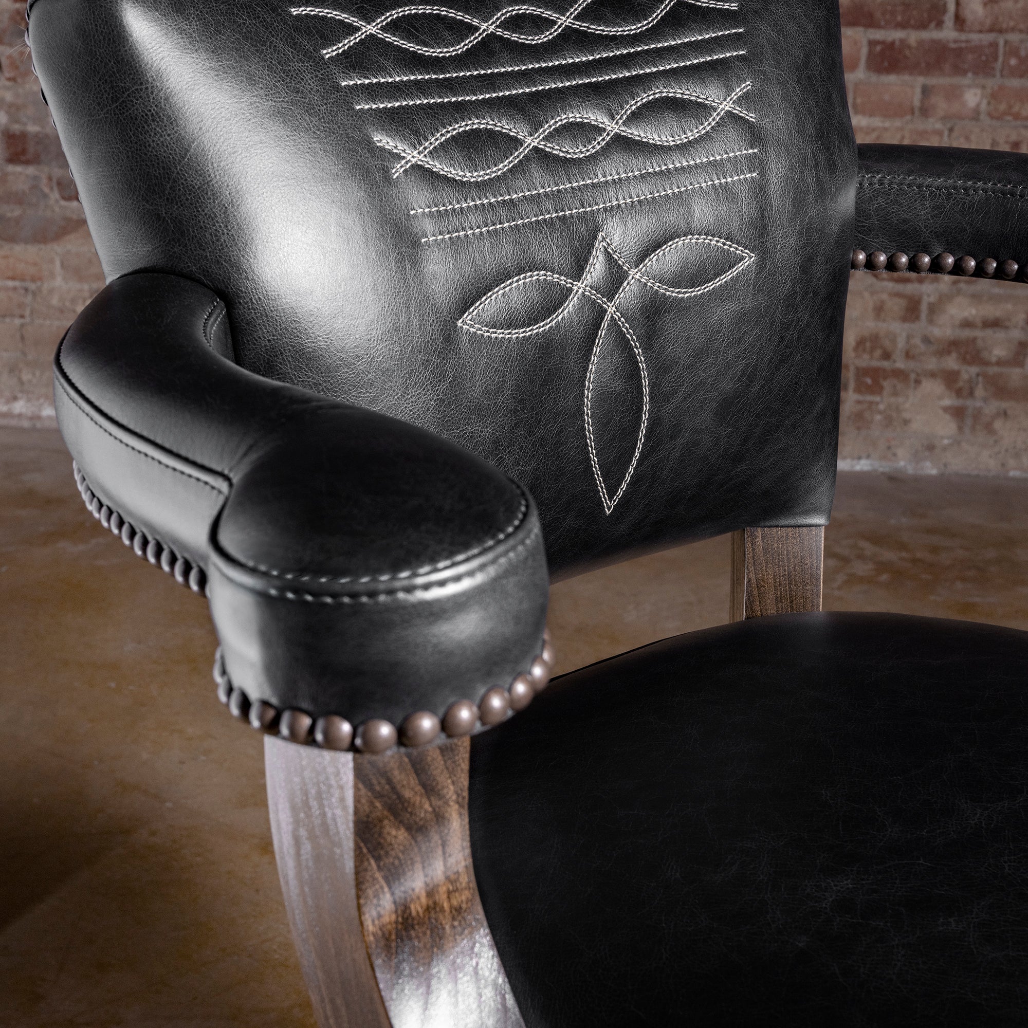 Stallion Grove Bar Stool western axis hide bar stool arm detail with black top-grain leather, nailhead trim, and tailored Western craftsmanship