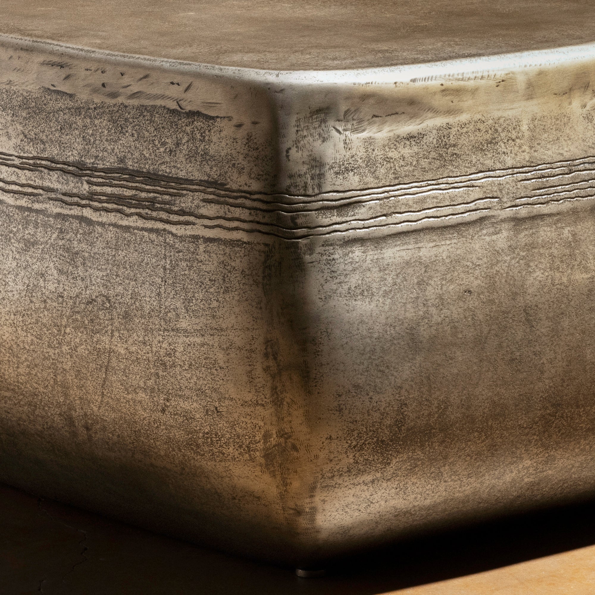 Sterling Range Forge Low Western Metal Coffee Table western coffee table with a low sculptural form, softened corners, and silver finish.