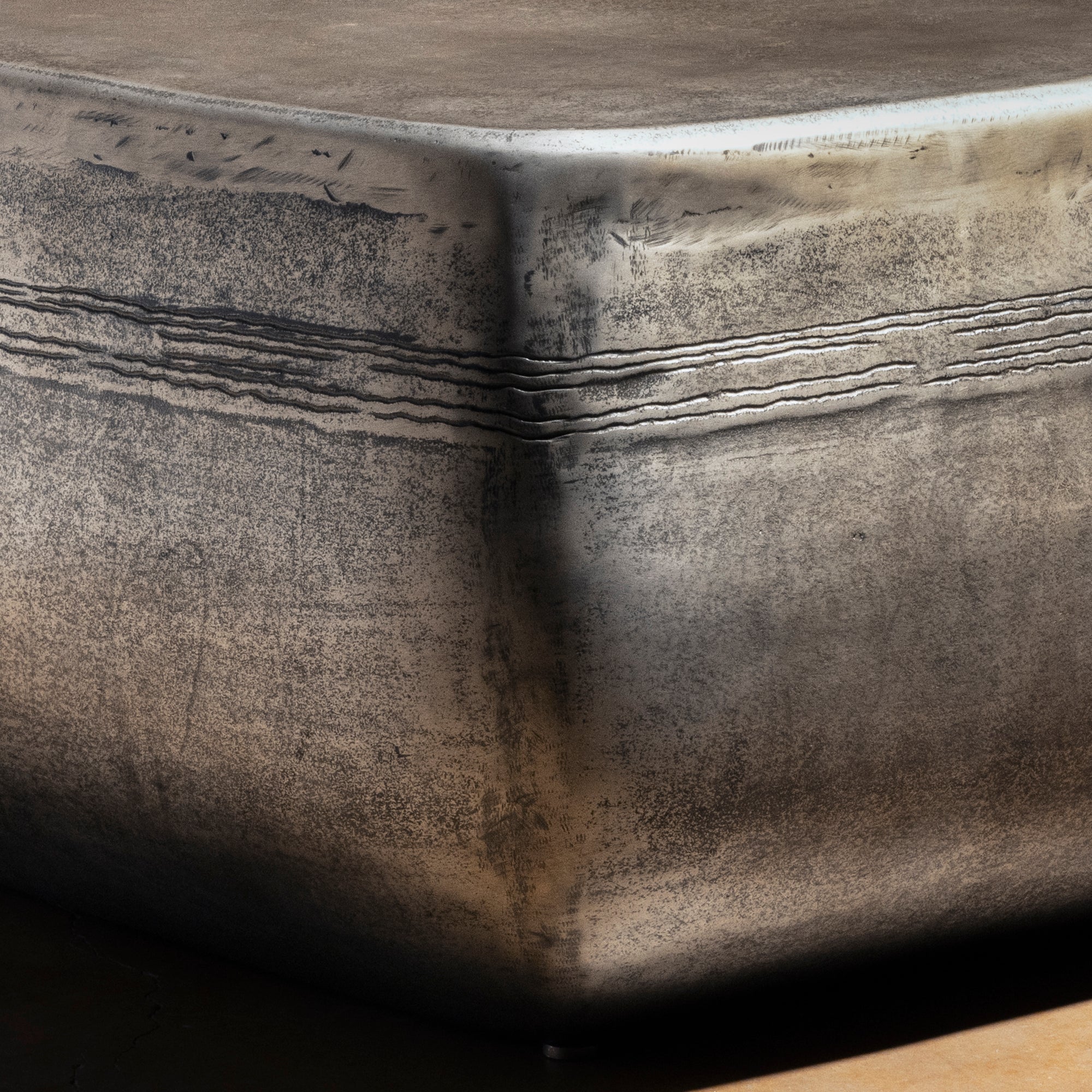 Sterling Range Forge Low Western Metal Coffee Table western coffee table with a low sculptural form, softened corners, and silver finish.