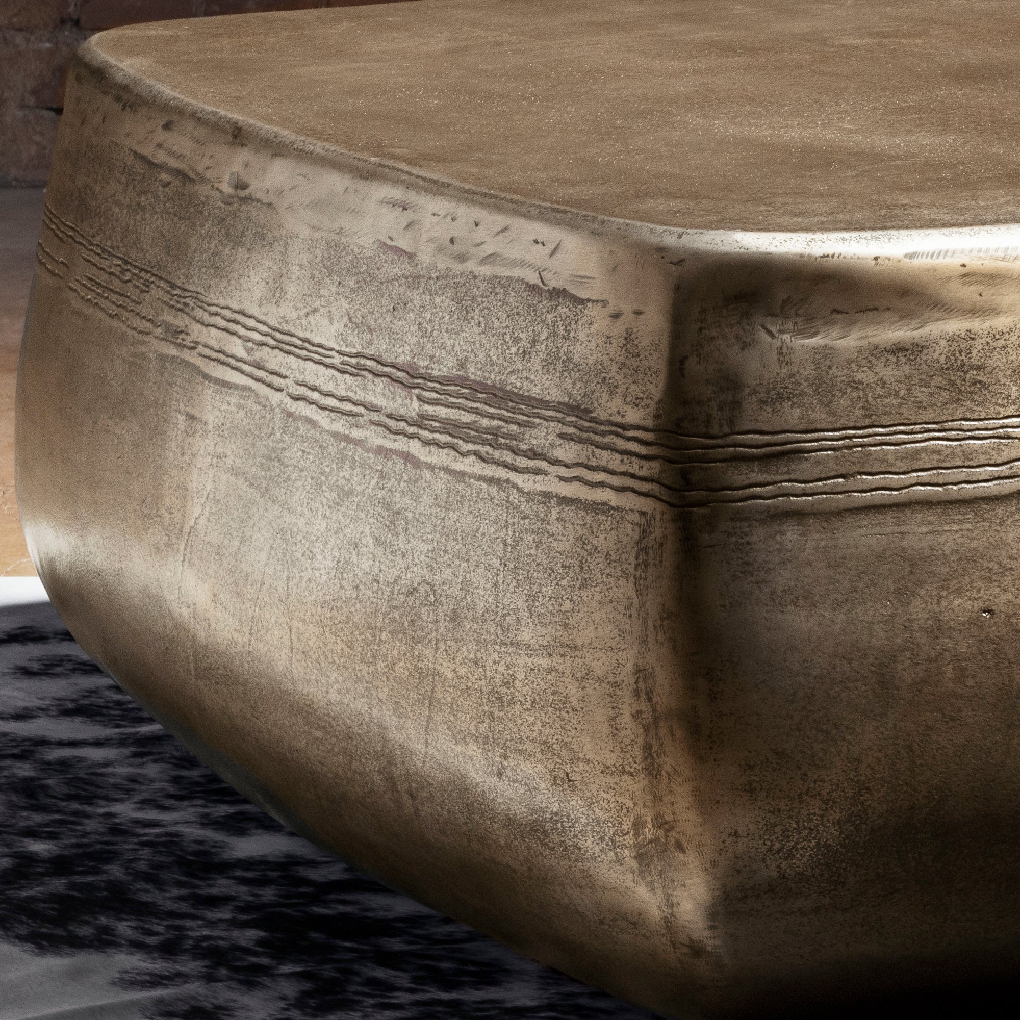 Sterling Range Forge Low Western Metal Coffee Table western coffee table close-up with hand-worked top texture and burnished metal edge.