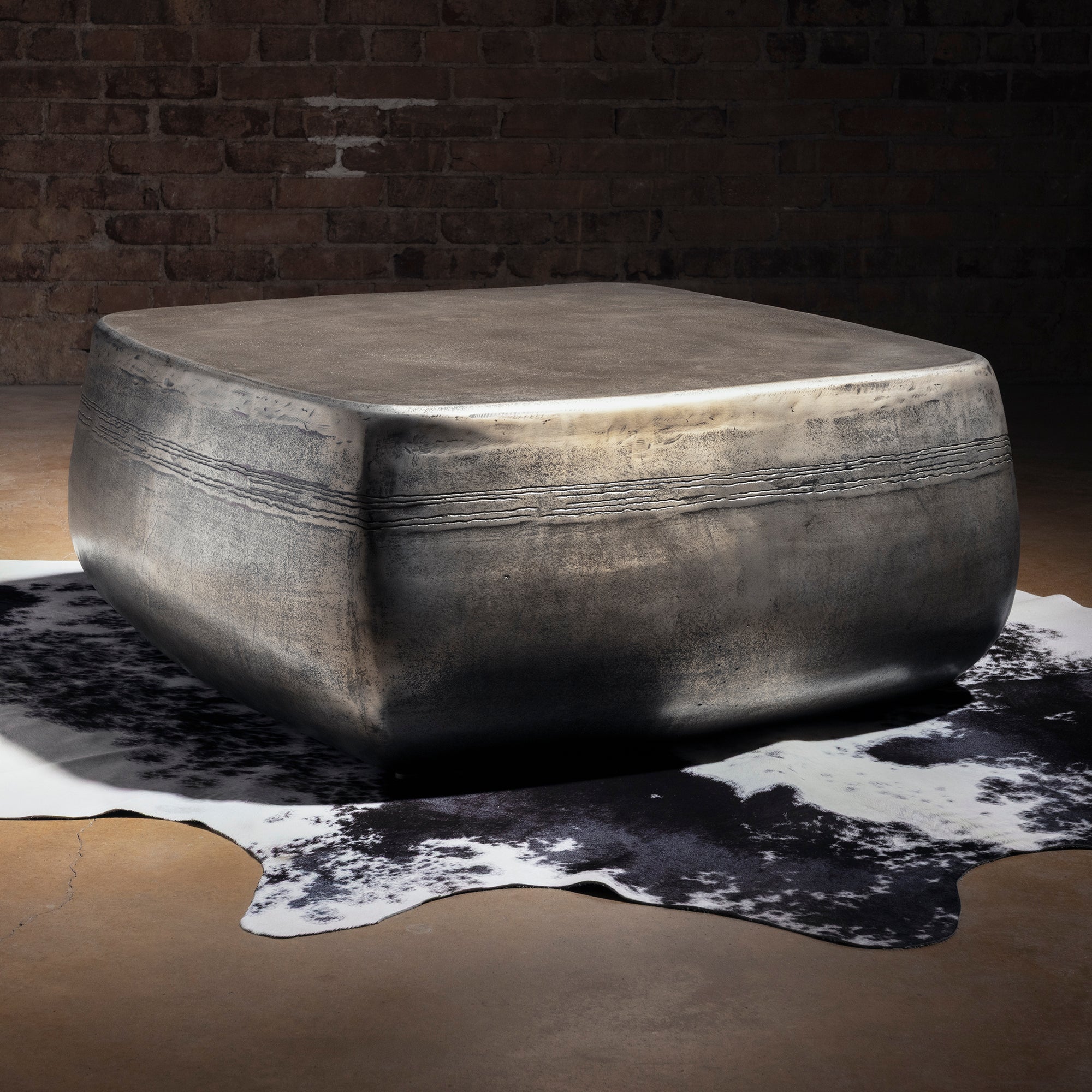 Sterling Range Forge Low Western Metal Coffee Table western coffee table styled on cowhide with rounded edges and hand-worked metal.