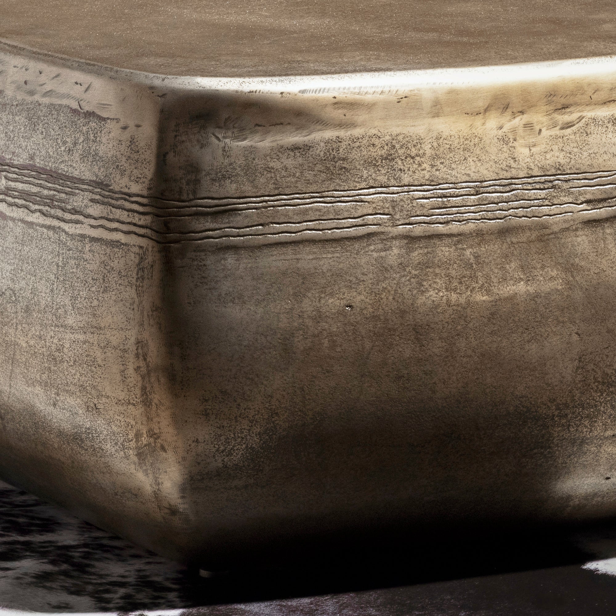 Sterling Range Forge Low Western Metal Coffee Table western coffee table close-up with forged banding, silver patina, and softened corner.