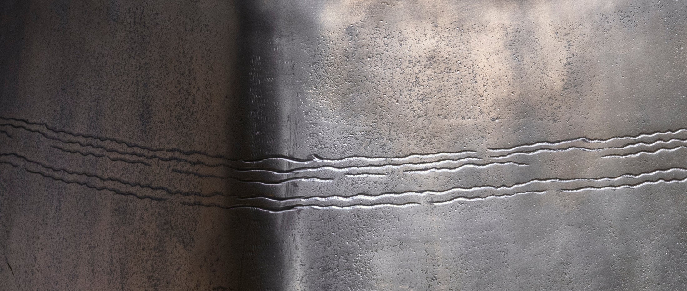 Sterling Spur Accent Table close-up of the silver metal accent table showing hand-textured finish, softened corners, and forged band detail