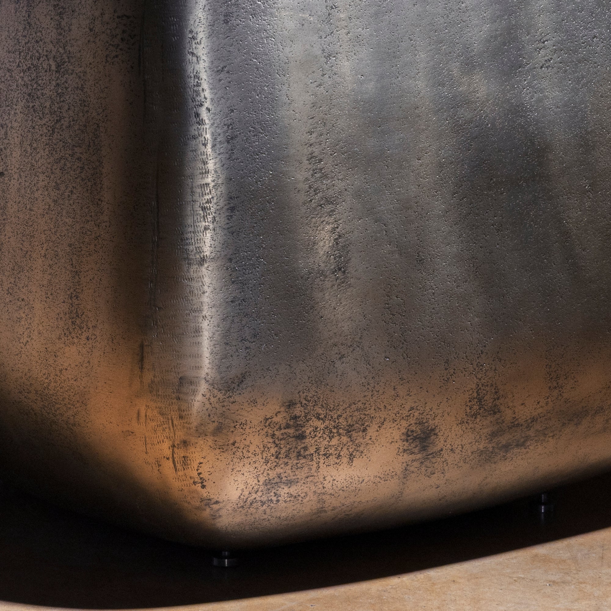 Sterling Spur Accent Table close-up of the silver metal accent table showing hand-textured finish, softened corners, and forged band detail