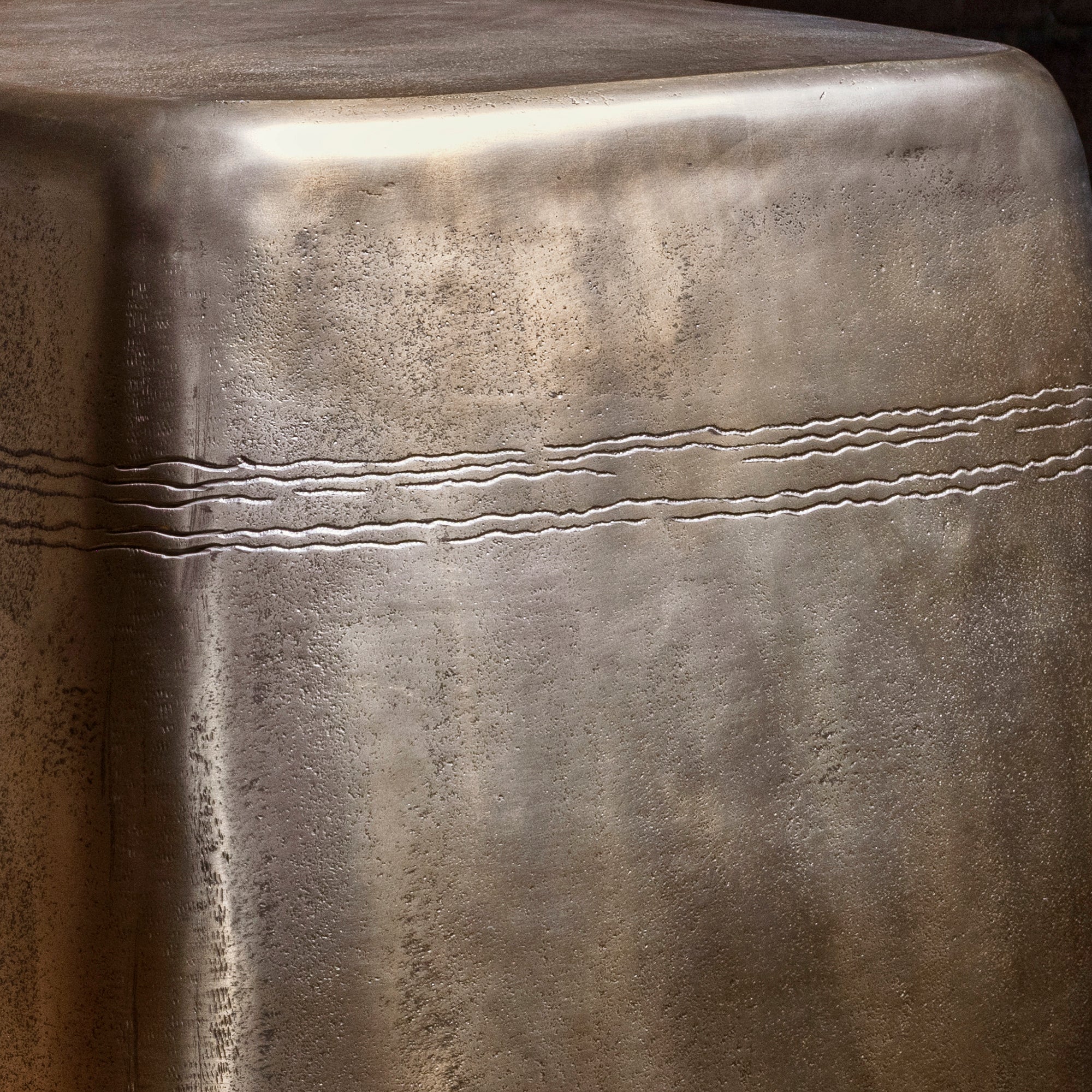 Sterling Spur Accent Table close-up of the silver metal accent table showing hand-textured finish, softened corners, and forged band detail