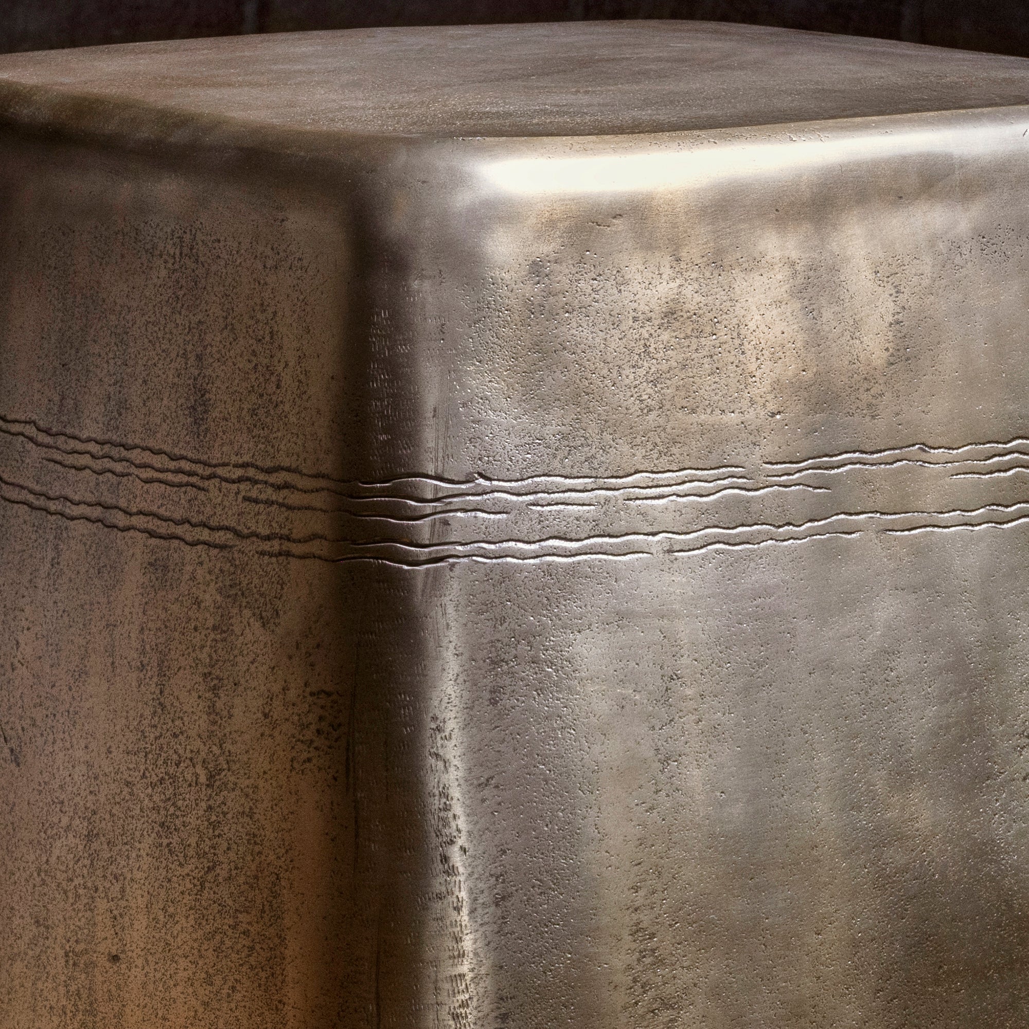 Sterling Spur Accent Table close-up of the silver metal accent table showing hand-textured finish, softened corners, and forged band detail