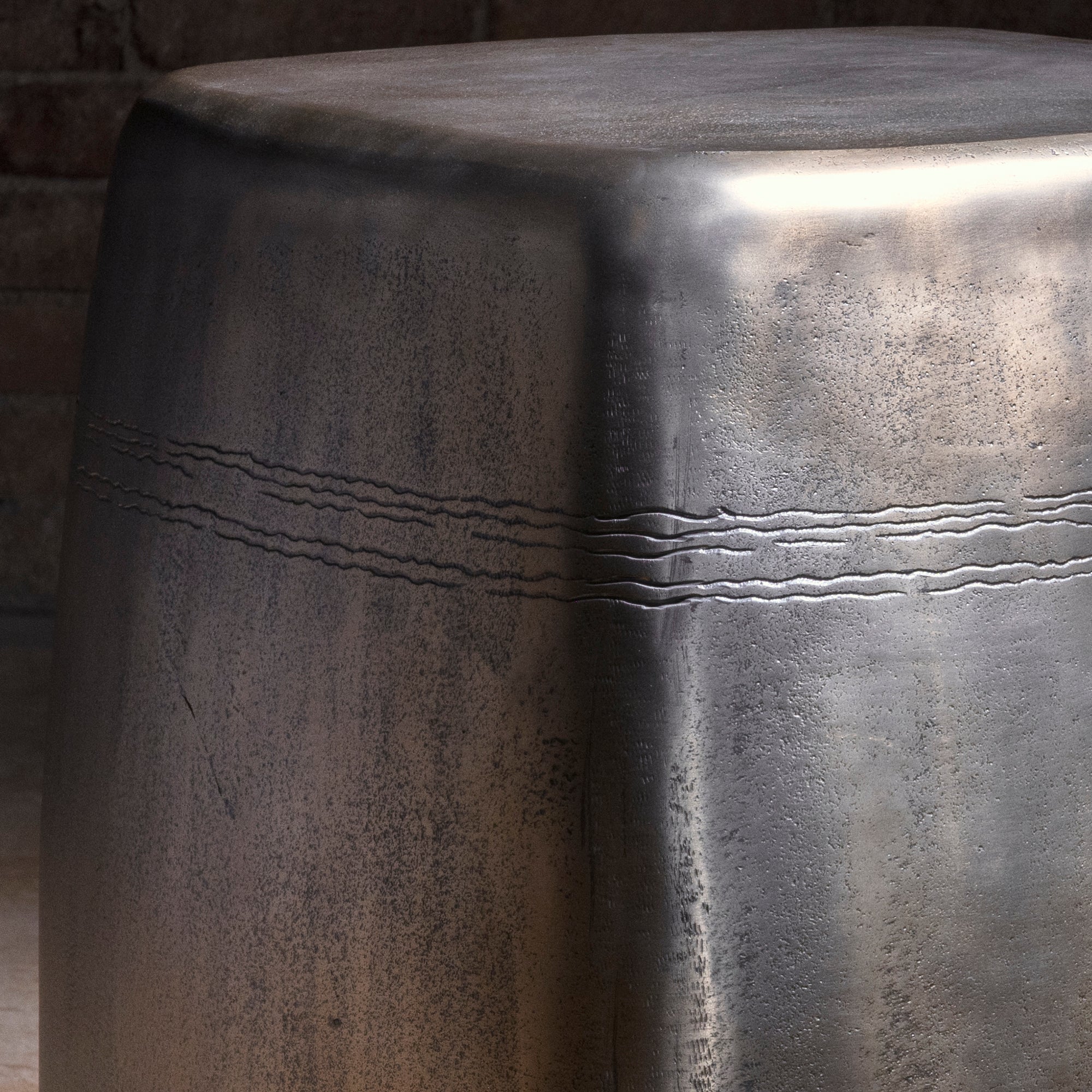 Sterling Spur Accent Table close-up of the silver metal accent table showing hand-textured finish, softened corners, and forged band detail