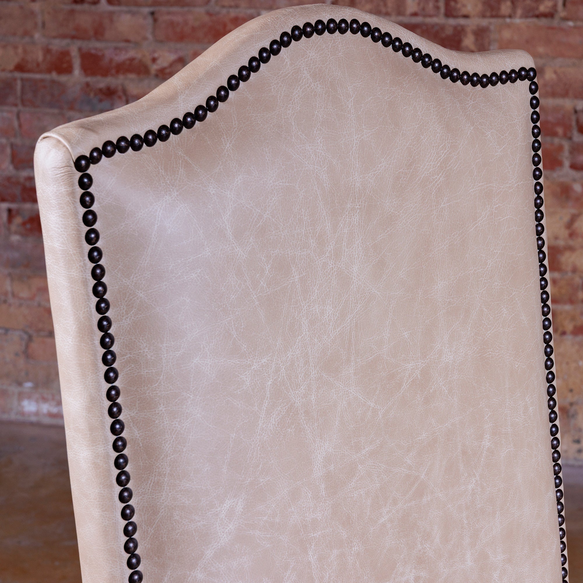 Hand-applied antique nailhead trim on Western leather dining chair