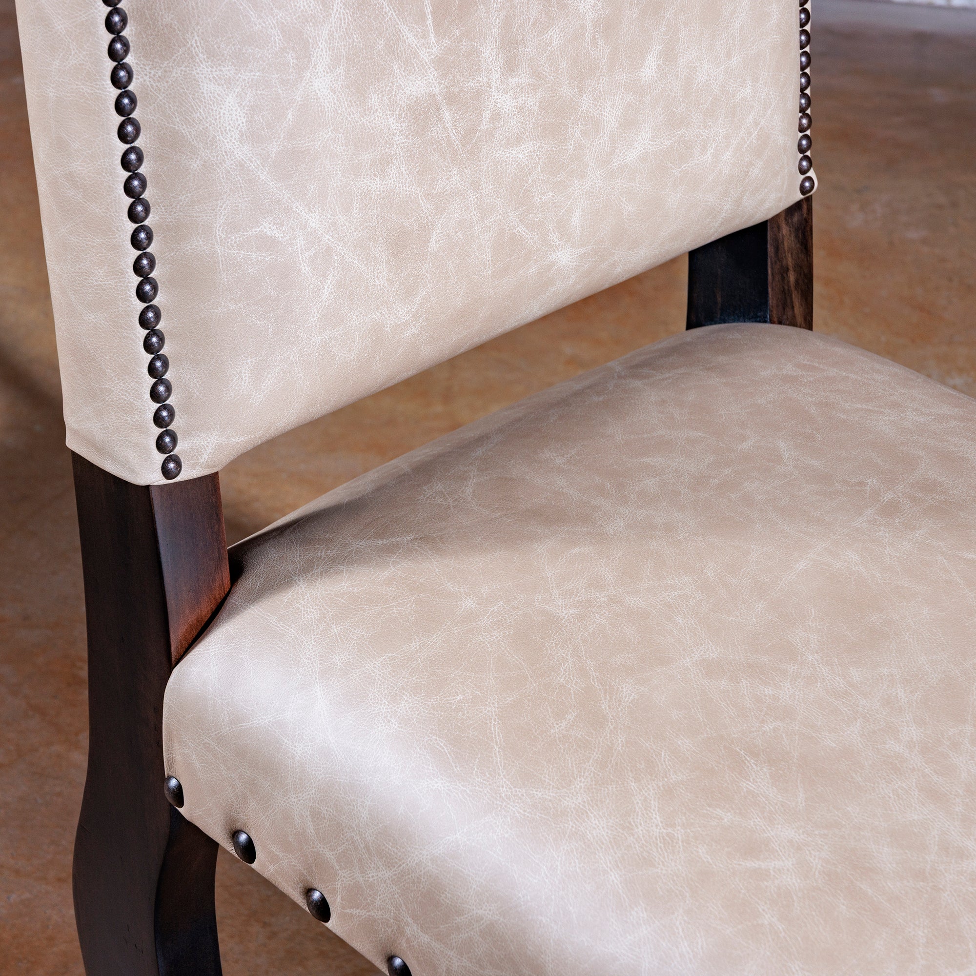 Seat detail of Sonora Highback Dining Chair in creamy top-grain leather