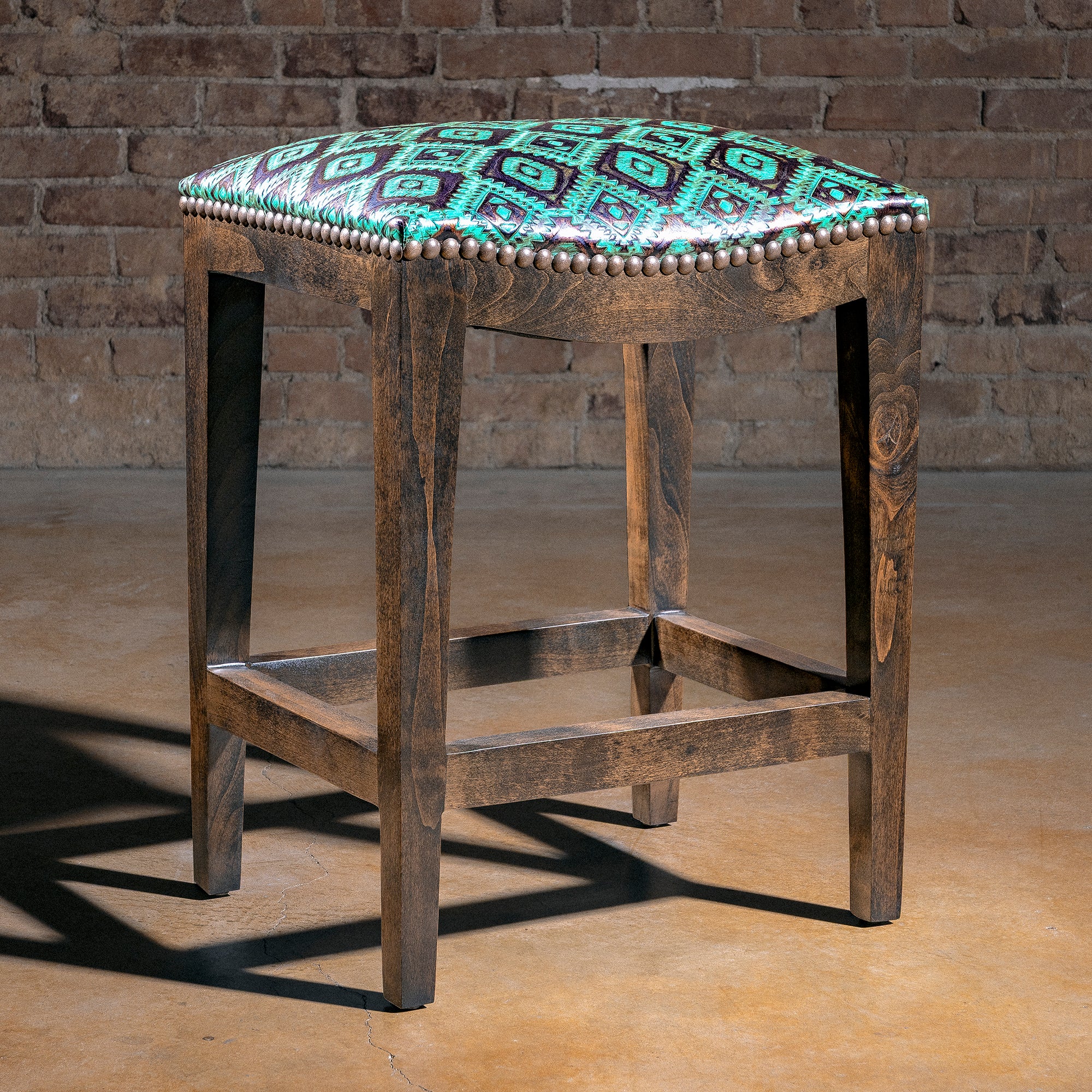 Verdigris Saddle Stool western bar stool with turquoise tooled leather seat, bronze nailhead trim, and alder wood base