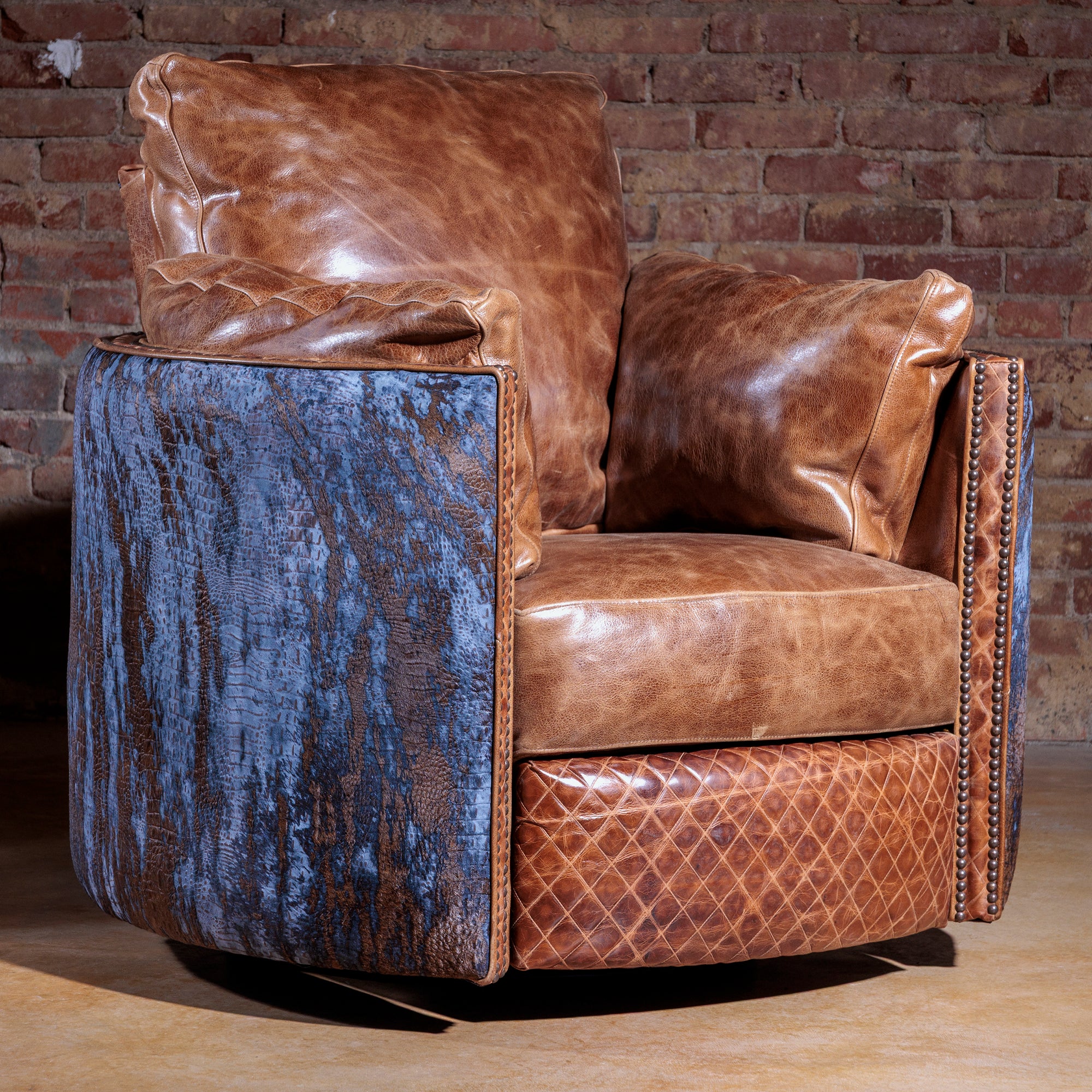 Top-grain leather cuddler chair with rustic Western design and push-back recline