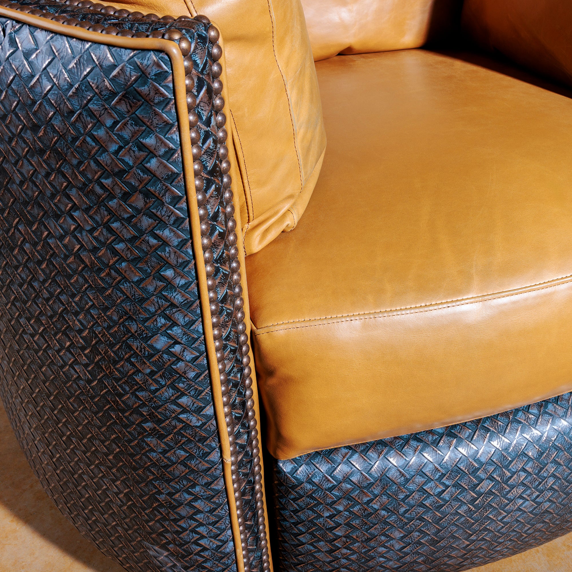 Close-up of top-grain leather and antique nailhead trim on Western