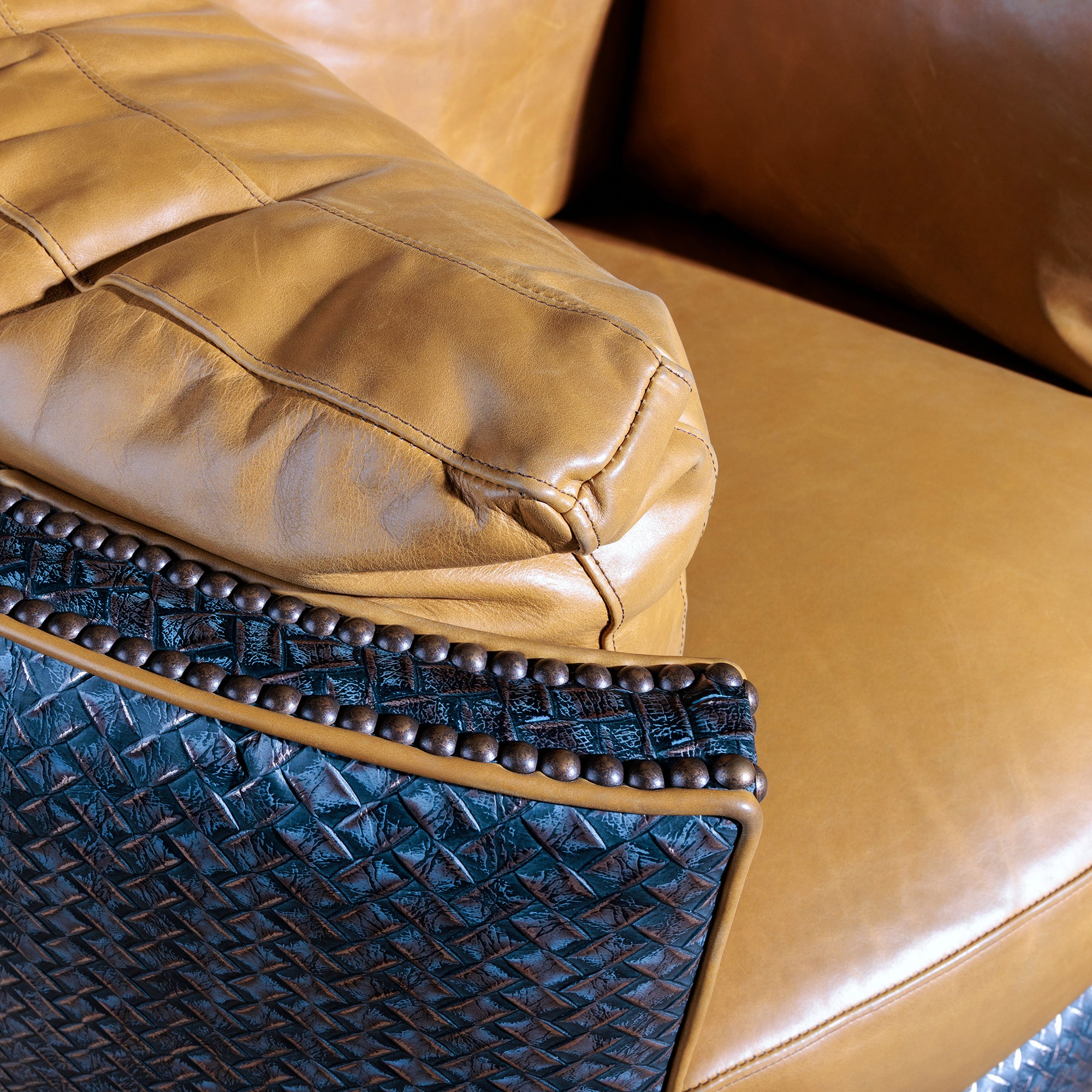 Close-up of premium top-grain leather and antique nailhead trim on Western leather recliner