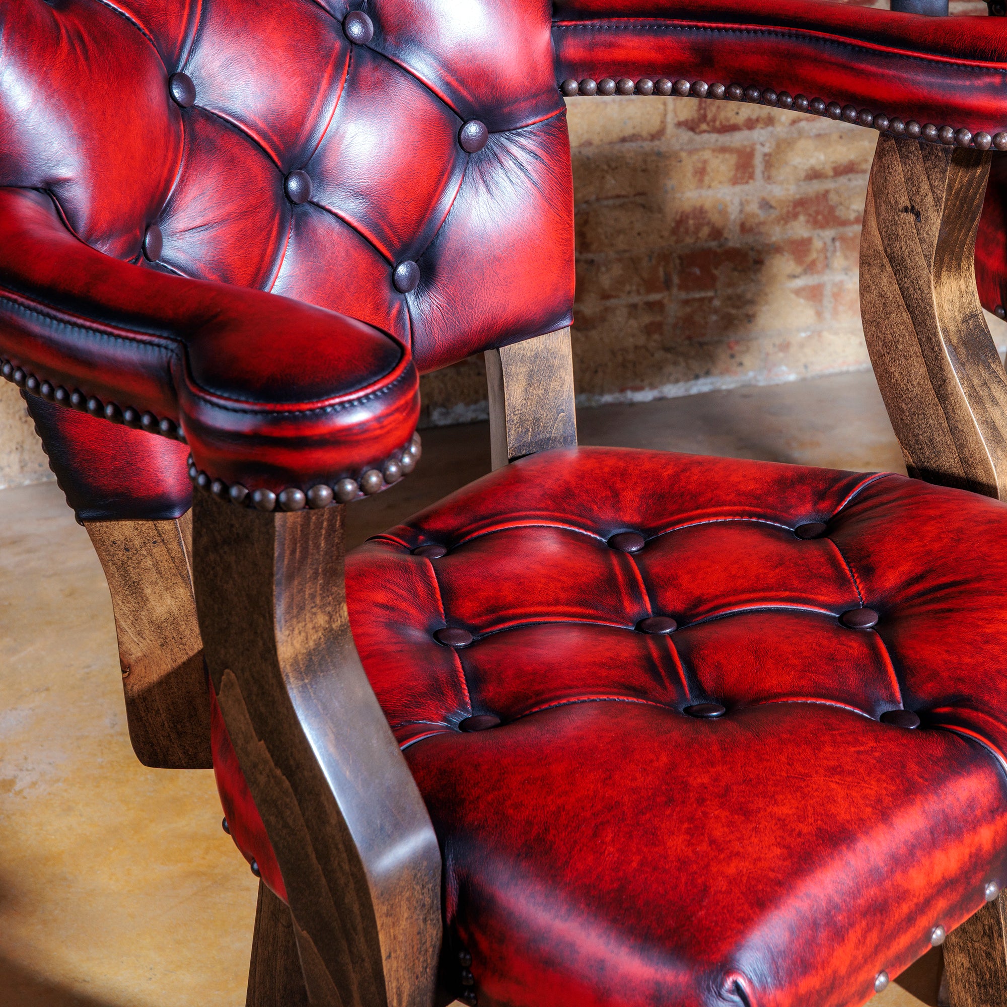 Hand-rubbed red leather and tufting on luxury bar stool