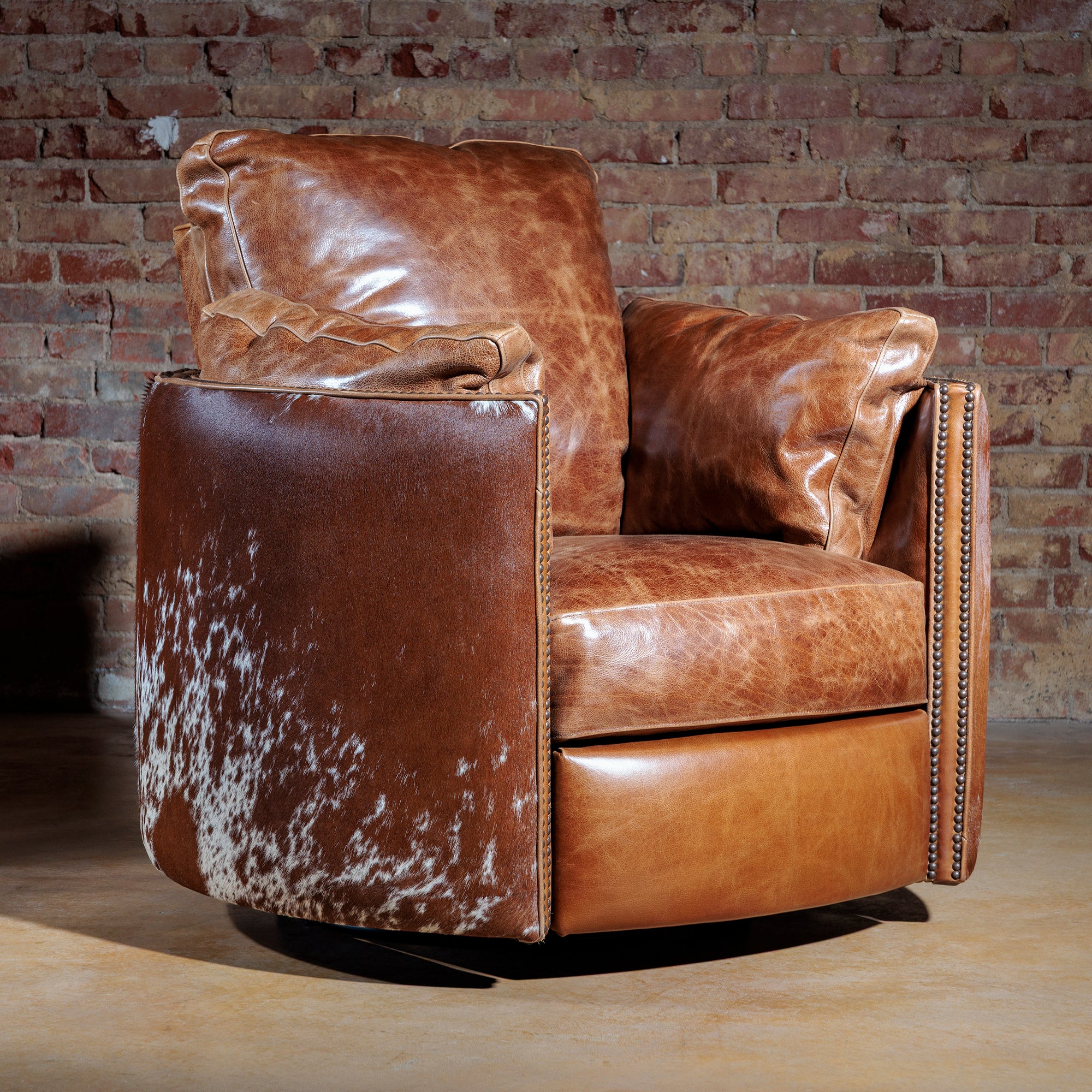 Side view of oversized cowhide Western recliner with nailhead trim and top-grain leather upholstery