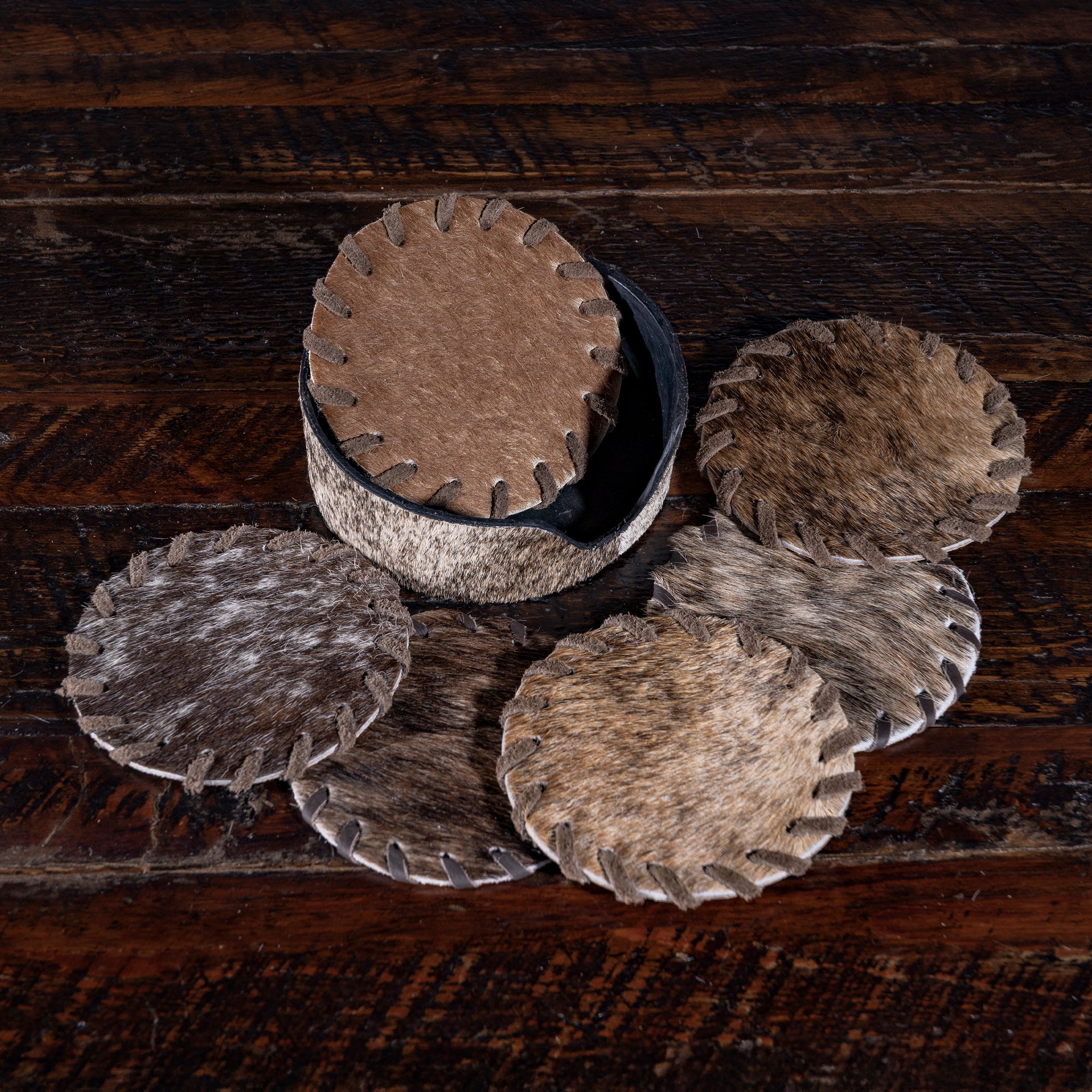 Genuine cowhide coasters from Into The West — handcrafted Western drinkware accessory and hostess gift.