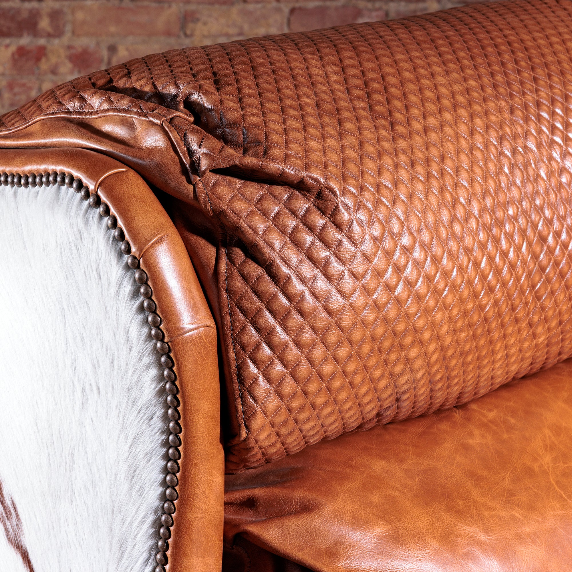 Detail view of the western leather cowhide recliner headrest detail